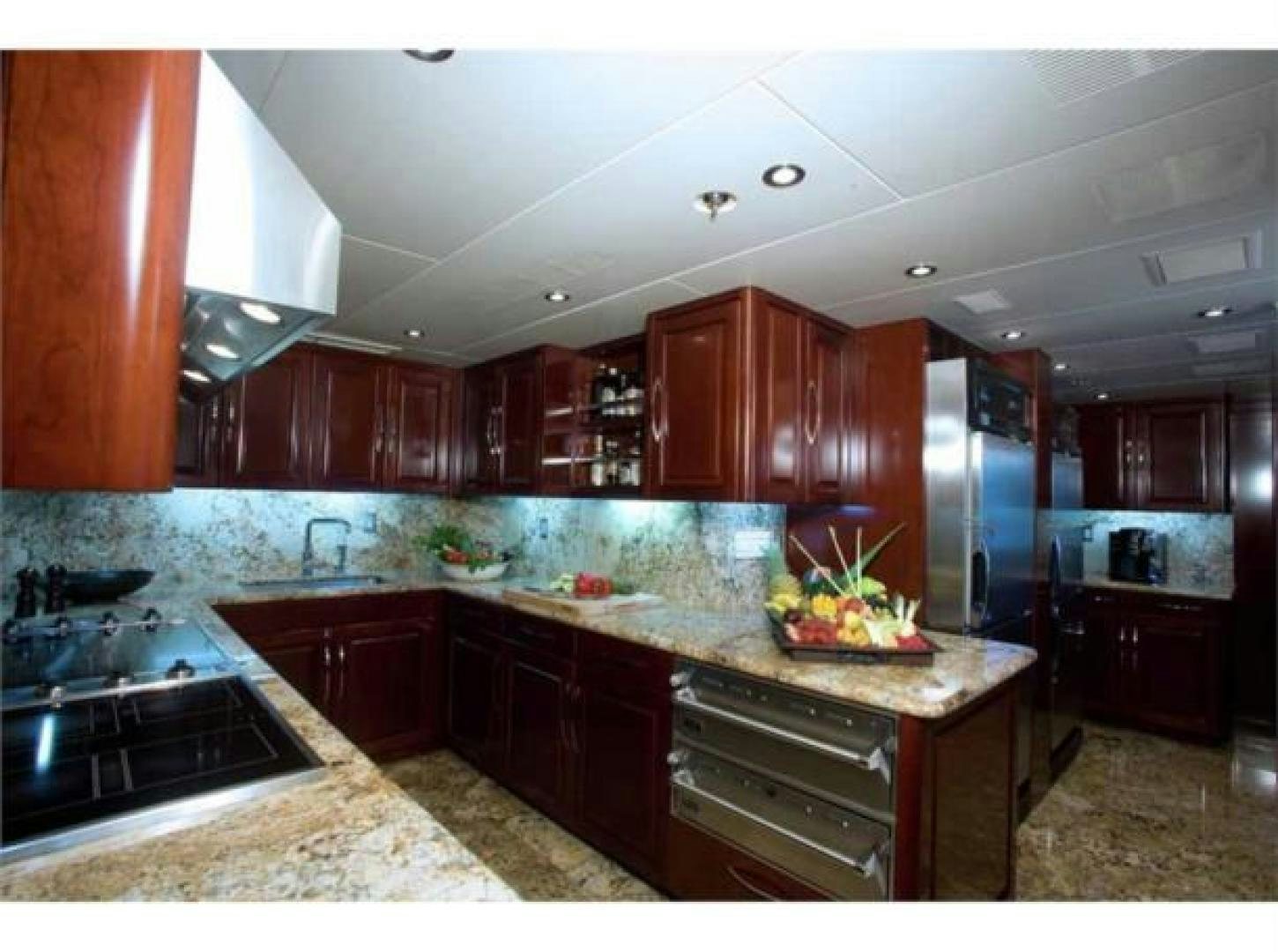 a kitchen with wooden cabinets aboard LADY JOY Yacht for Sale
