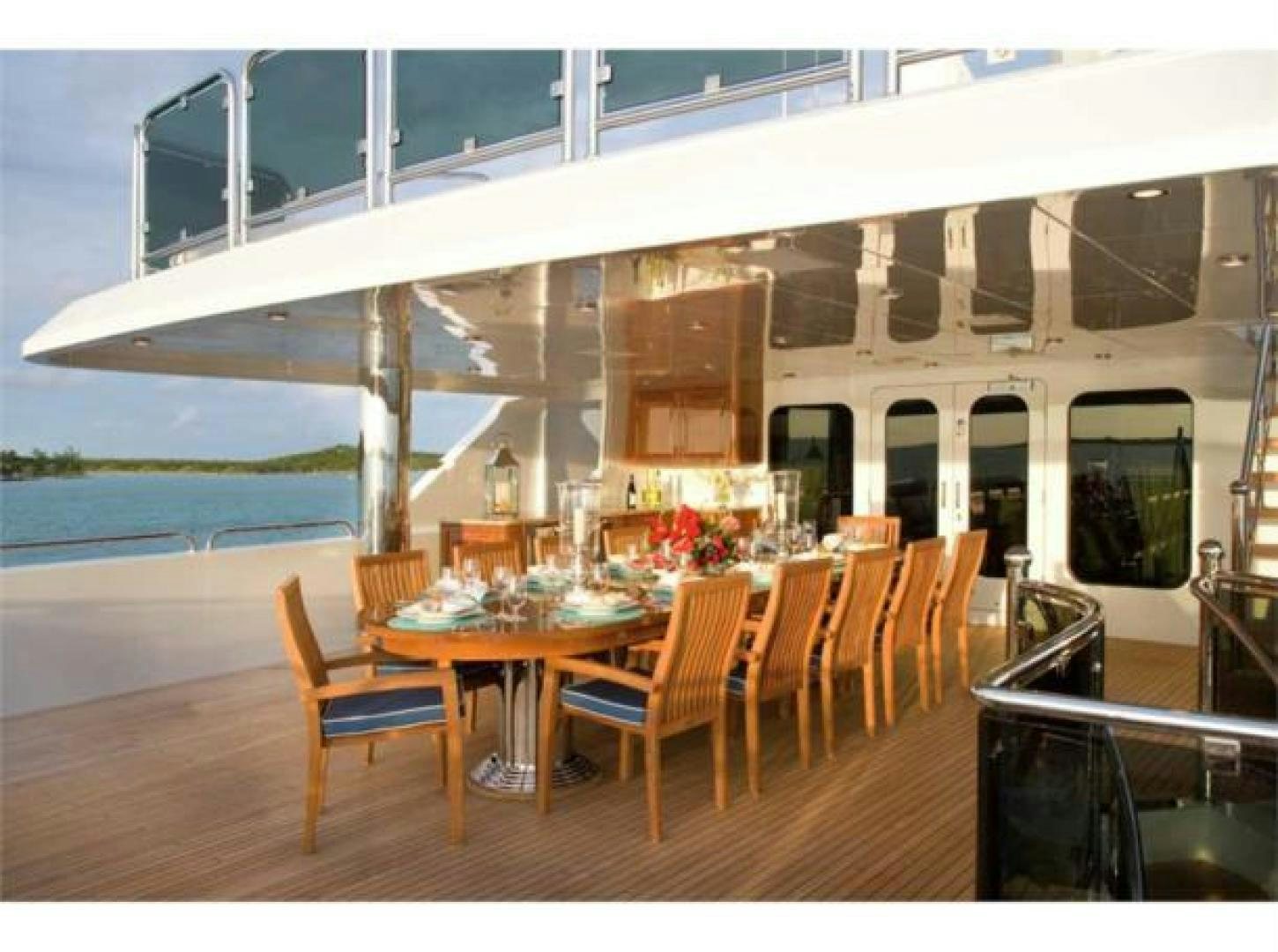 a room with tables and chairs aboard LADY JOY Yacht for Sale