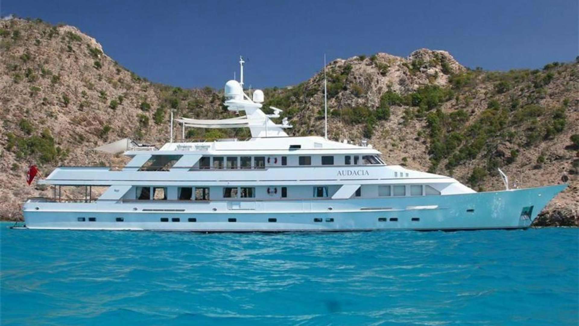 a large white boat in the water aboard GENESIA Yacht for Sale