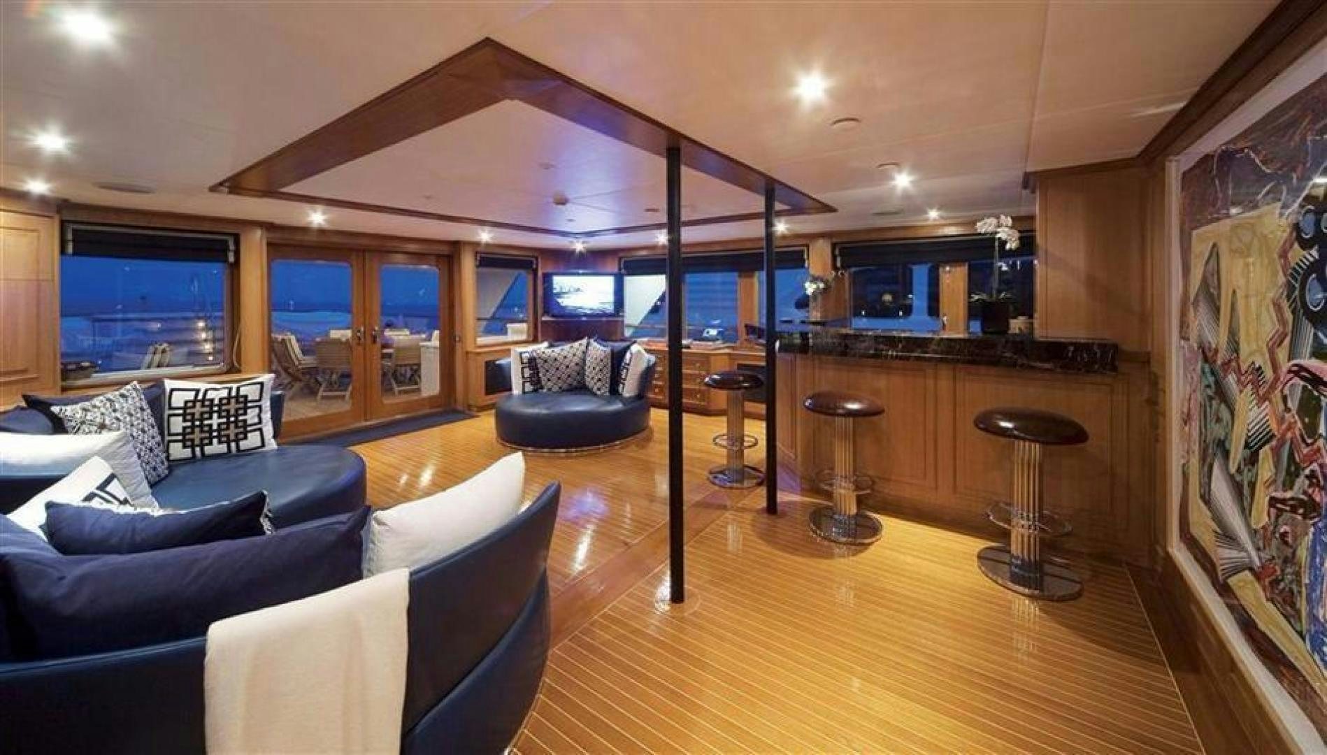 a living room with a wood floor aboard AUDACIA Yacht for Sale