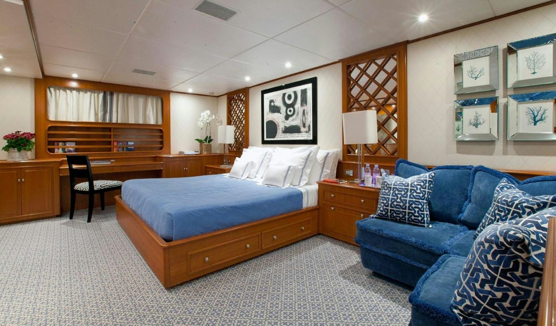 a bedroom with a blue bed aboard AUDACIA Yacht for Sale