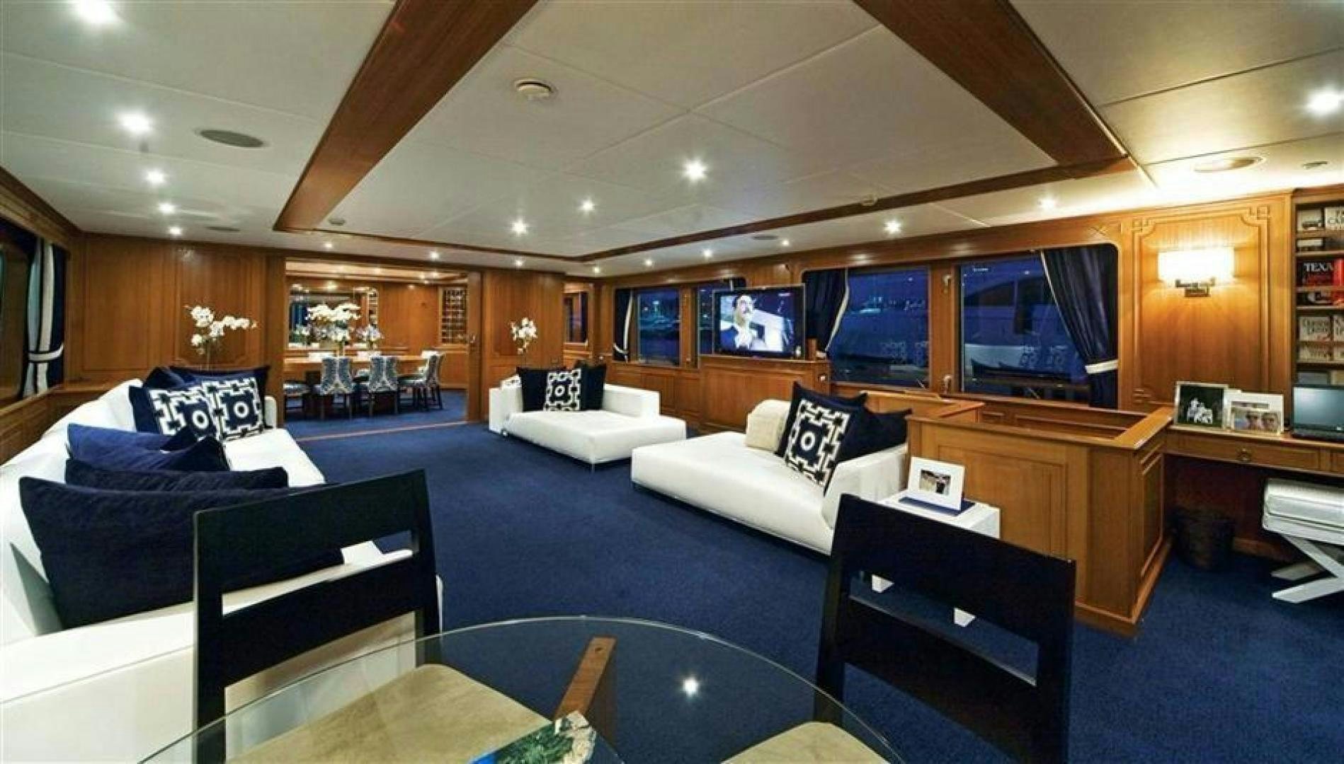 a room with a couch and a table and a tv aboard AUDACIA Yacht for Sale
