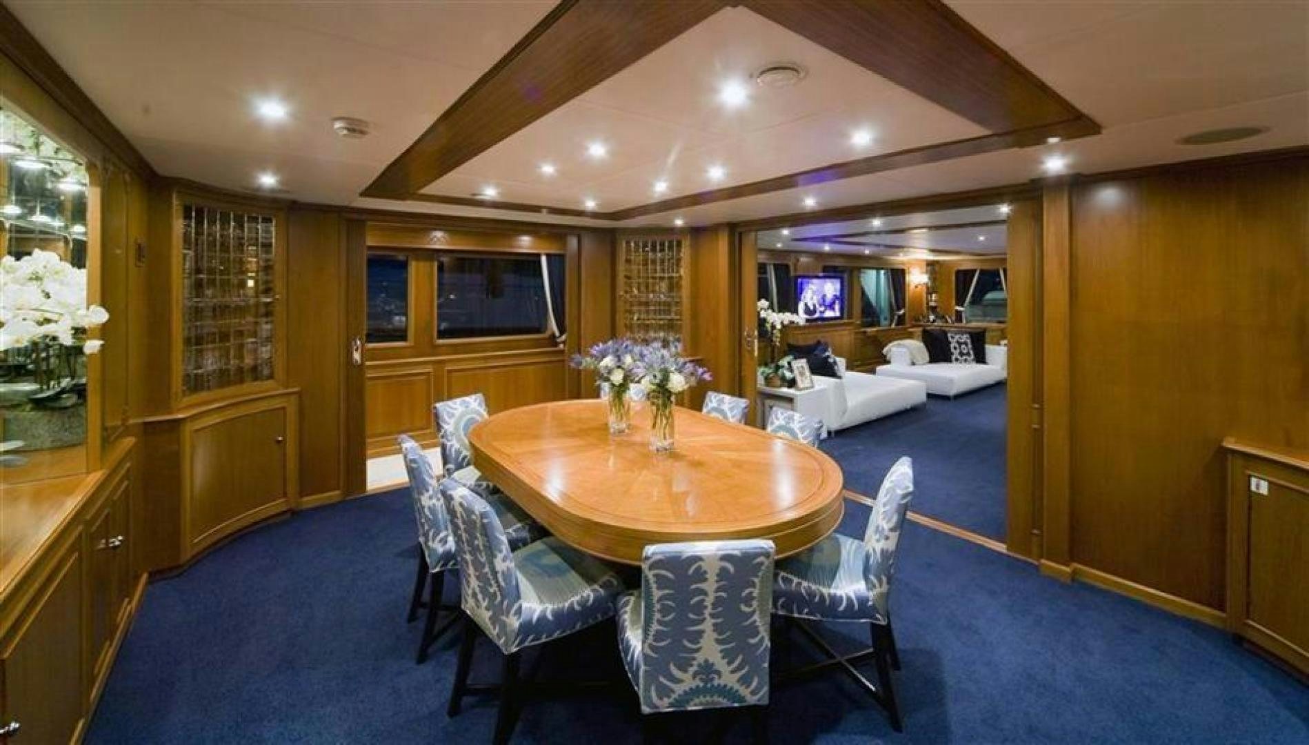 a dining table in a living room aboard AUDACIA Yacht for Sale
