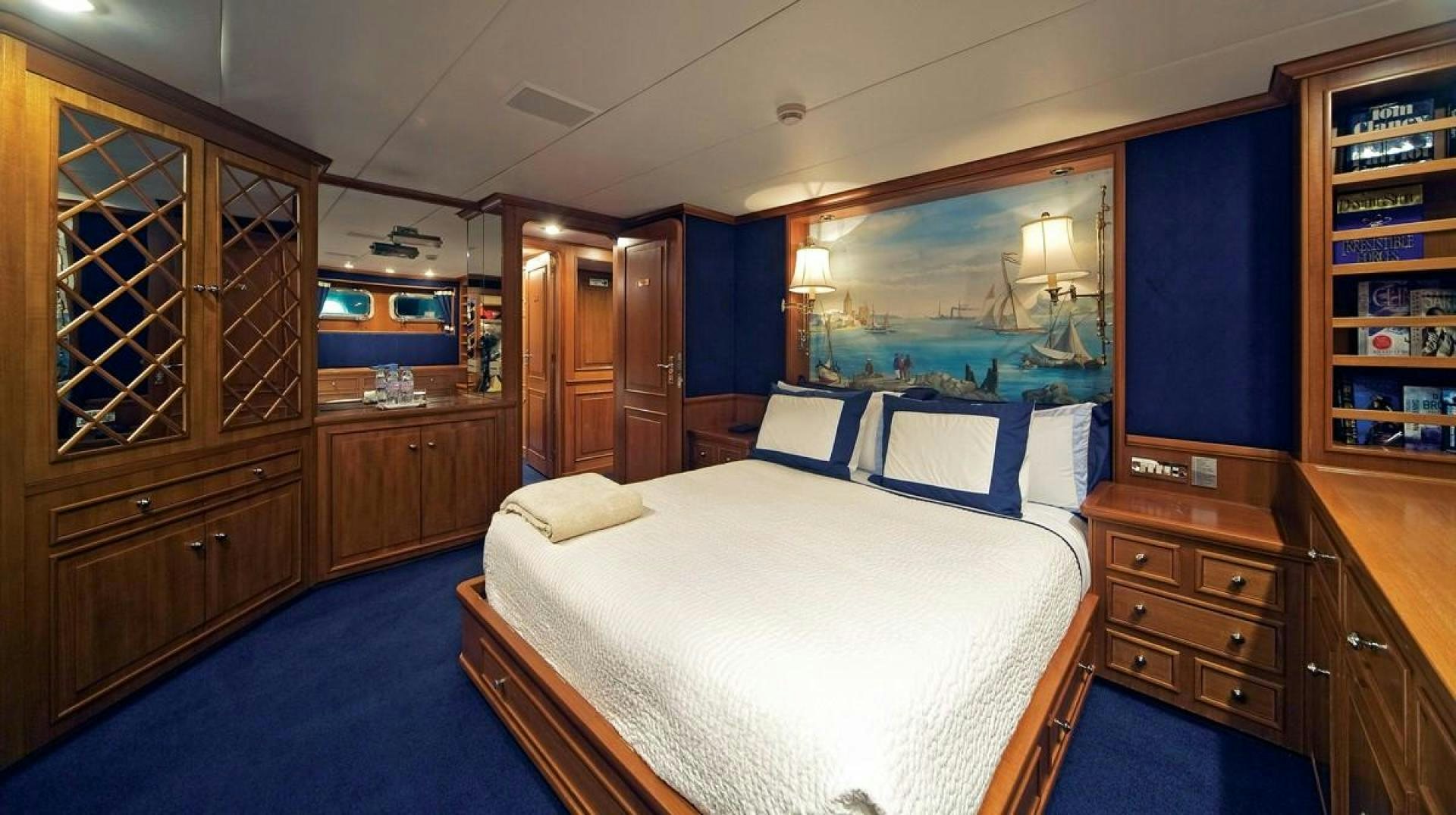 a bedroom with a bed and a cabinet aboard AUDACIA Yacht for Sale