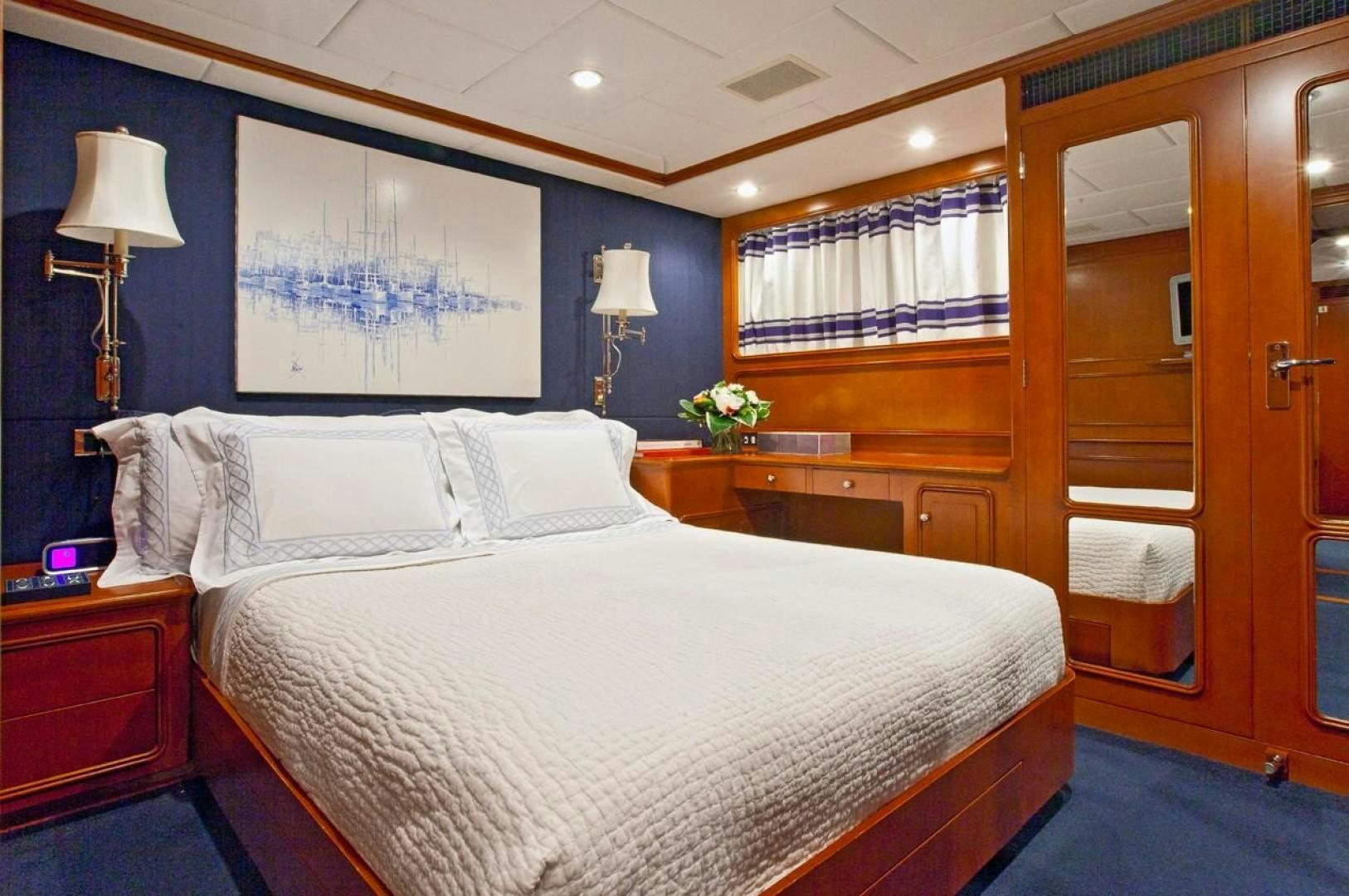 a bedroom with a bed and a desk aboard AUDACIA Yacht for Sale