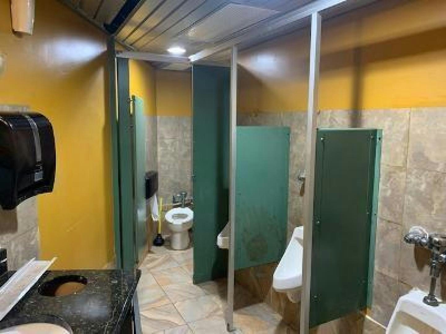 a bathroom with a urinal and a sink aboard No Name Yacht for Sale