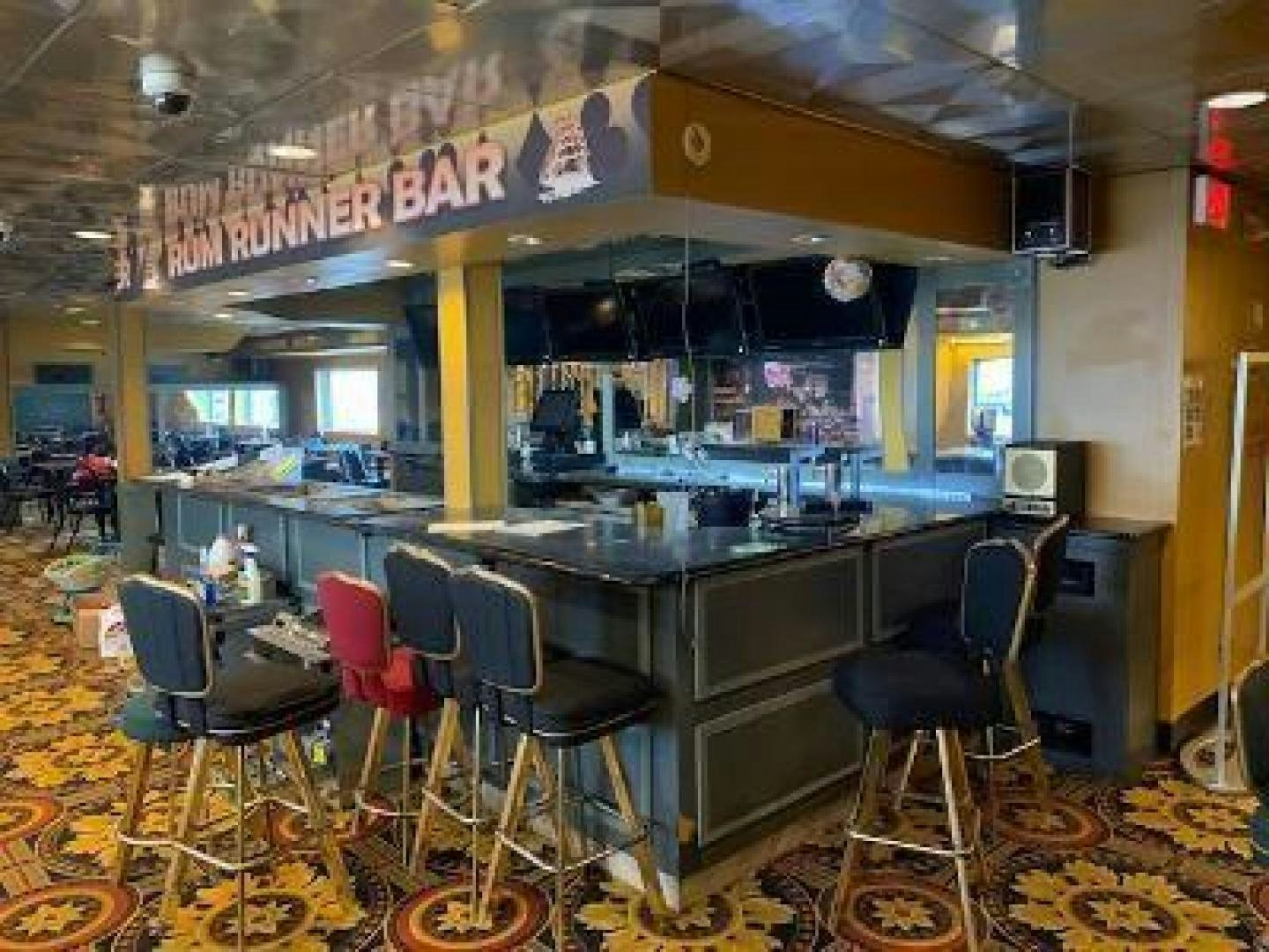 a large kitchen with a bar and chairs aboard No Name Yacht for Sale