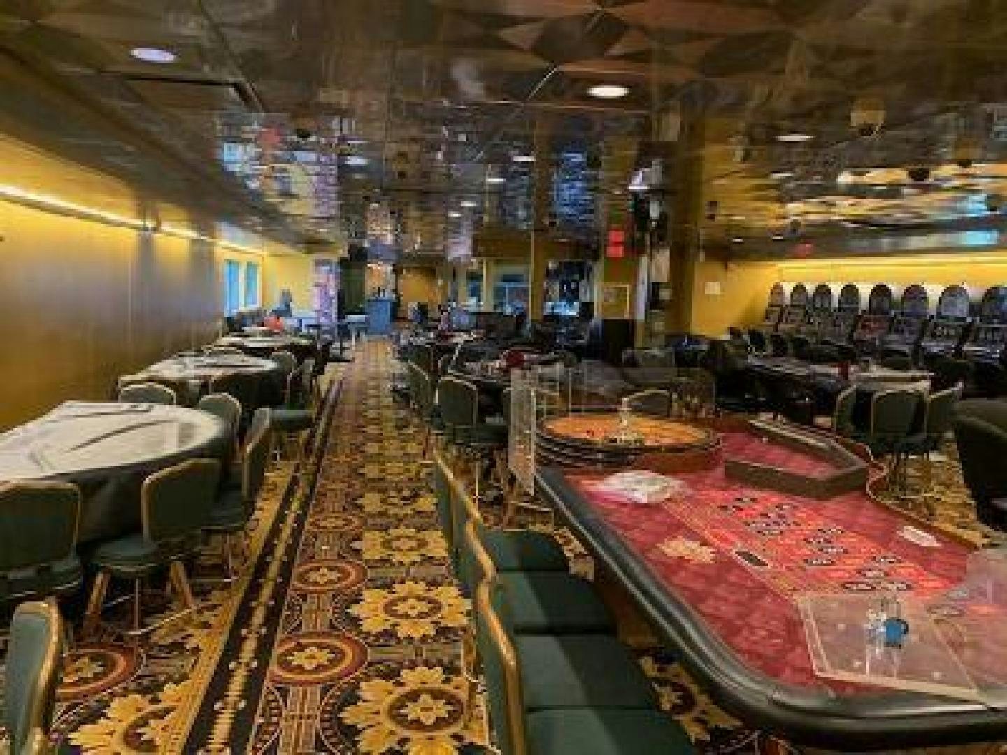 a bar with tables and chairs aboard No Name Yacht for Sale