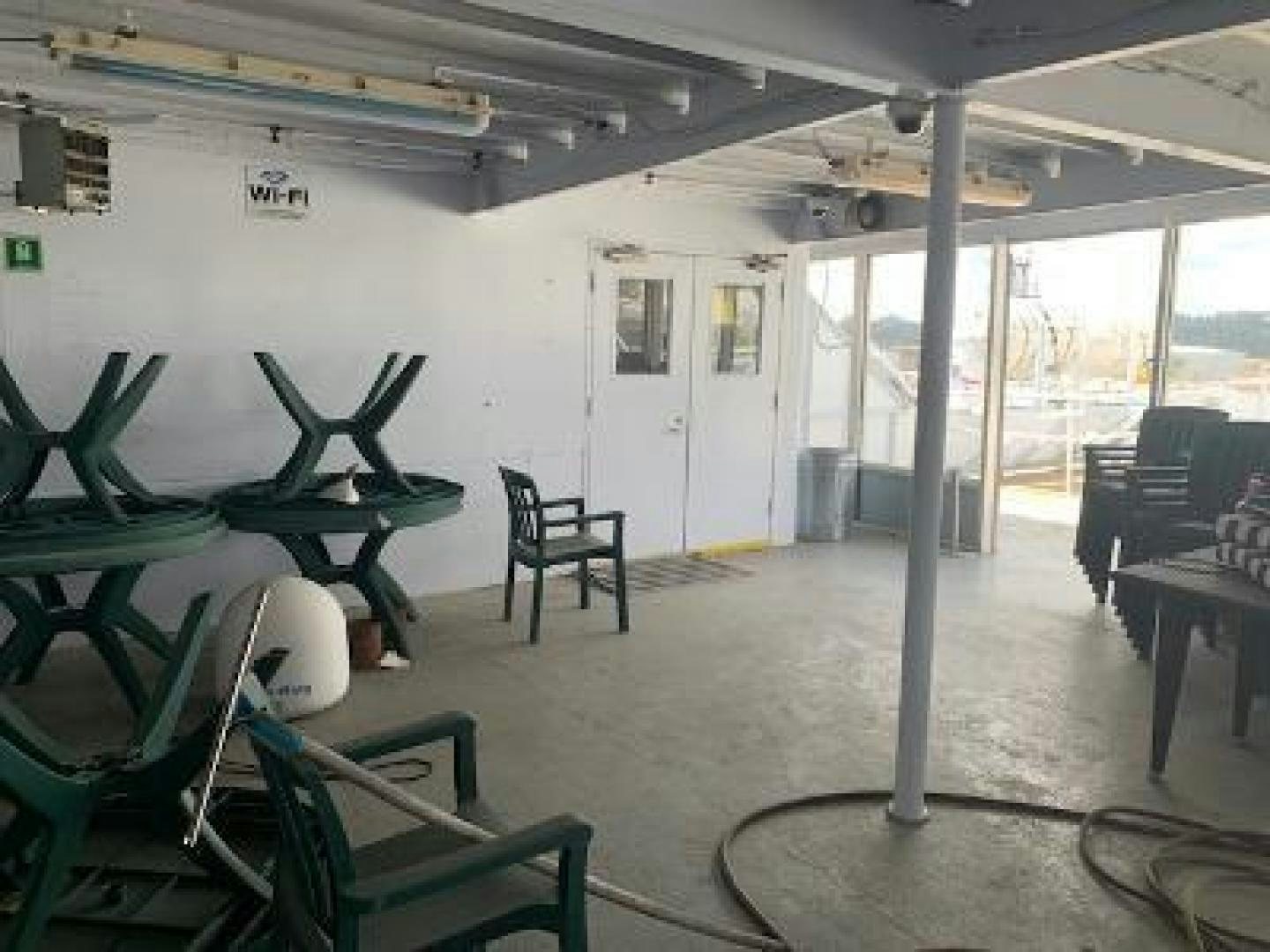 a room with chairs and tables aboard No Name Yacht for Sale