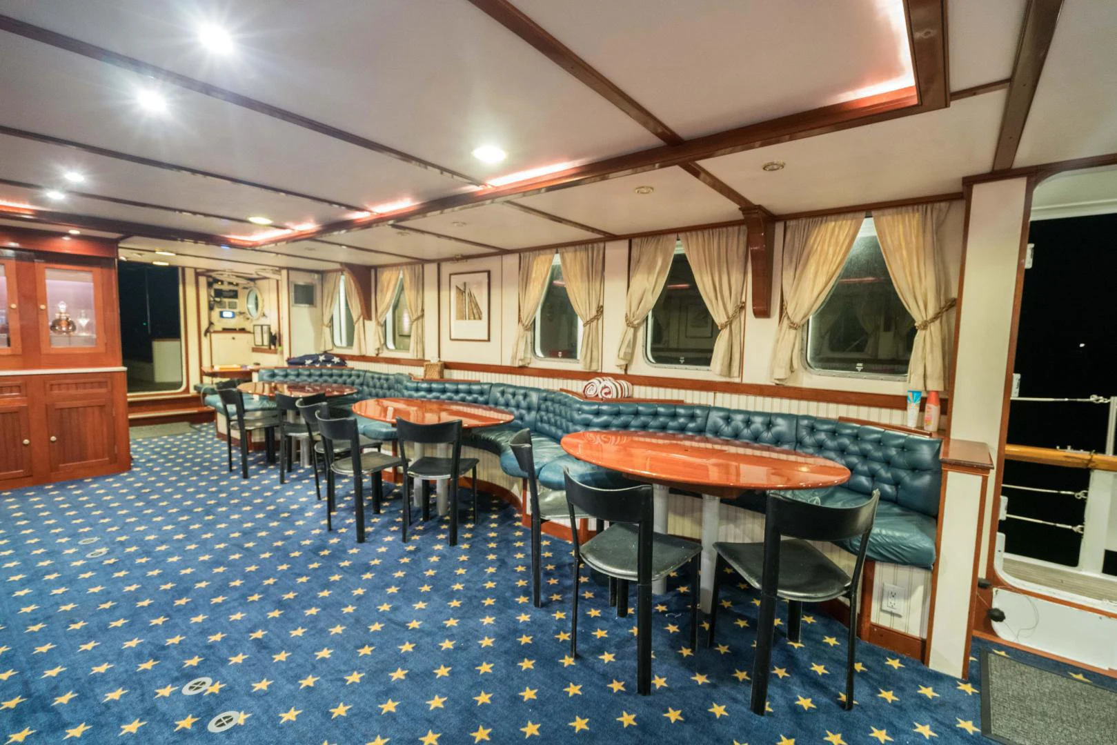 a room with tables and chairs aboard ARABELLA Yacht for Sale