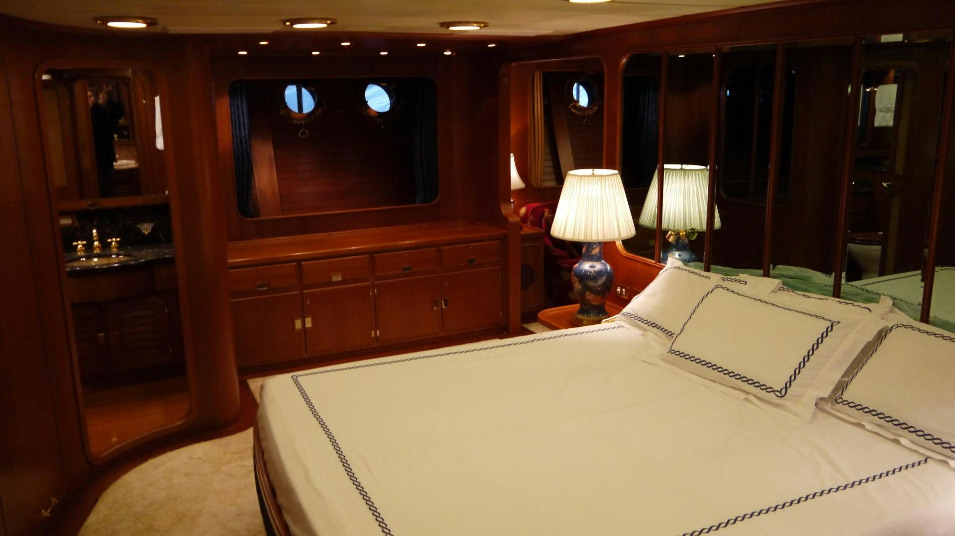 a room with a bed and a desk aboard ANDROMEDA LA DEA Yacht for Sale