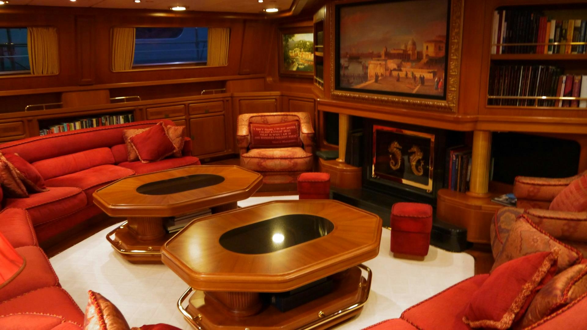 a living room with a fireplace aboard ANDROMEDA LA DEA Yacht for Sale