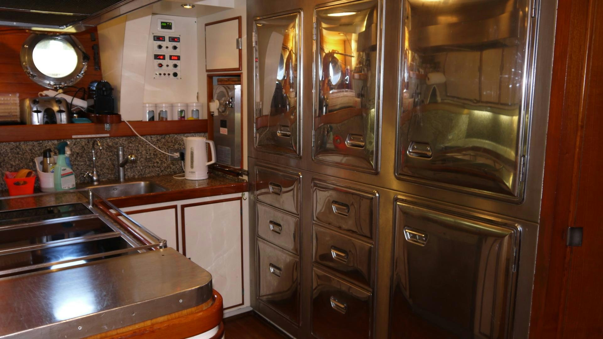 a kitchen with a stainless steel refrigerator aboard ANDROMEDA LA DEA Yacht for Sale