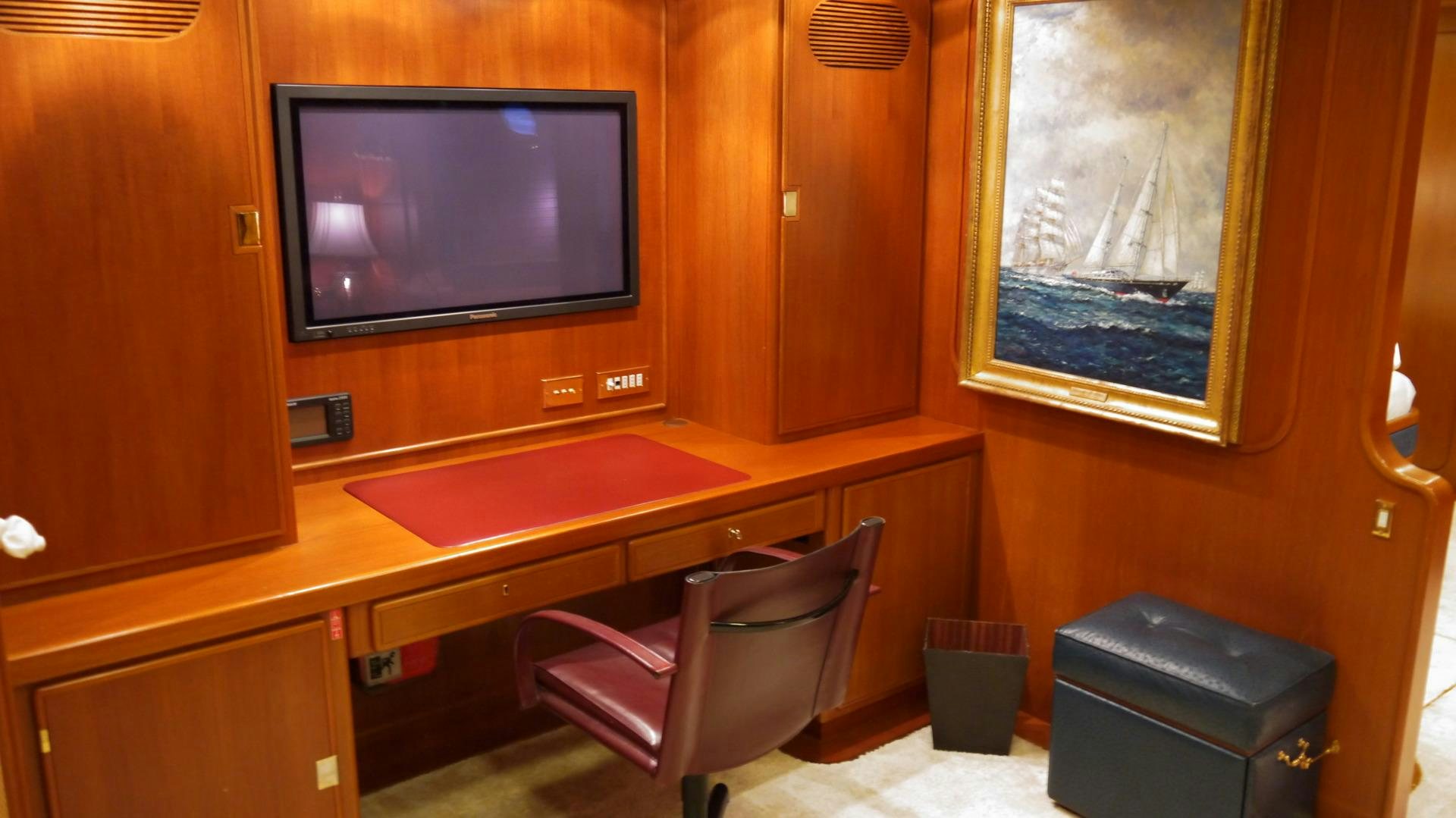 a room with a tv and a chair aboard ANDROMEDA LA DEA Yacht for Sale