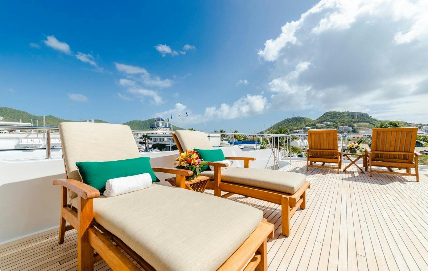 a deck with chairs and tables on it aboard POPEYE Yacht for Sale