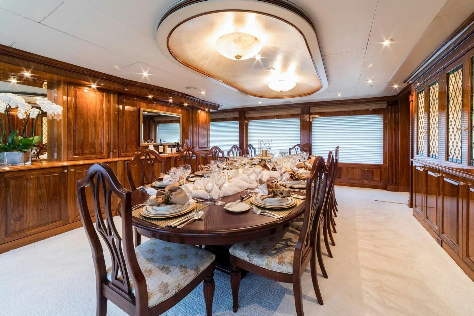 a dining room with a table set aboard POPEYE Yacht for Sale