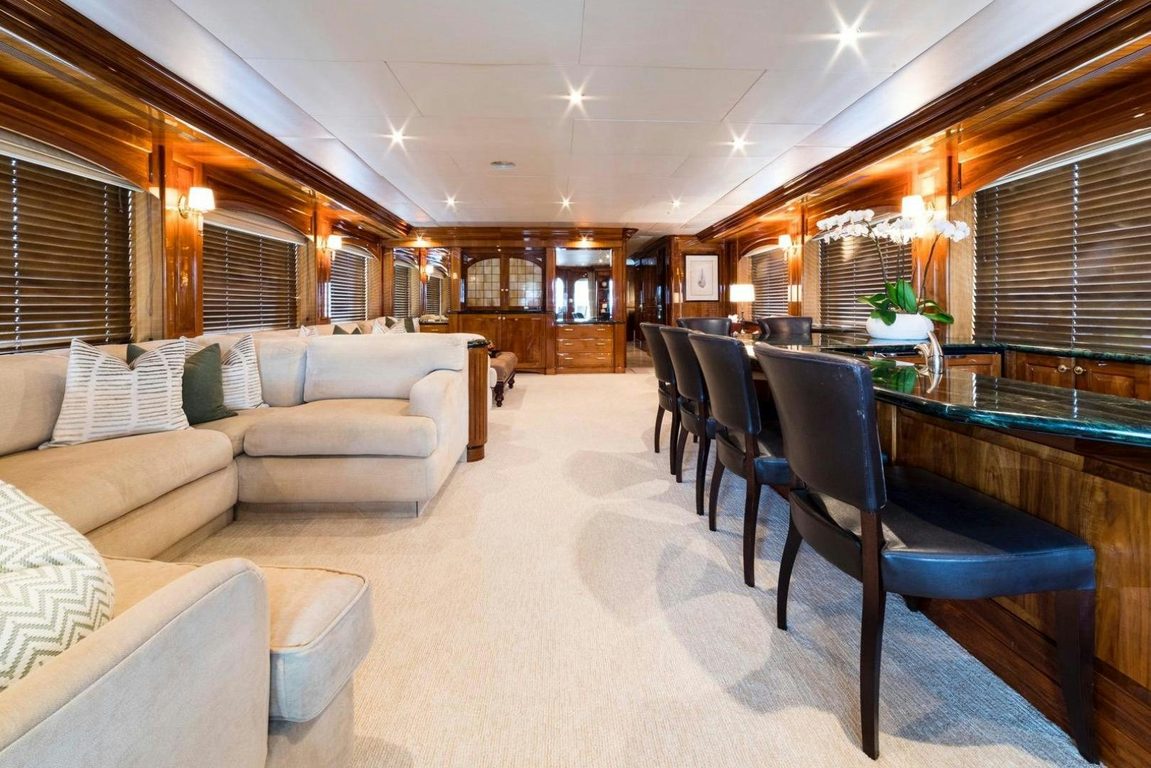 a living room with a large table and chairs aboard POPEYE Yacht for Sale