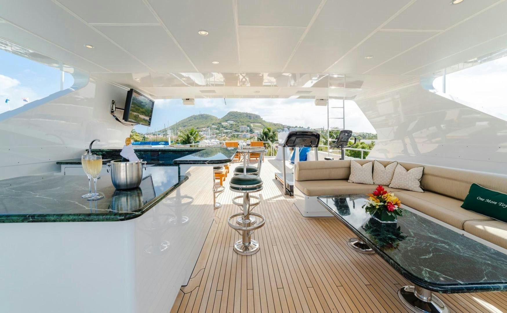 a modern living room with a glass table and a view of the mountains aboard POPEYE Yacht for Sale