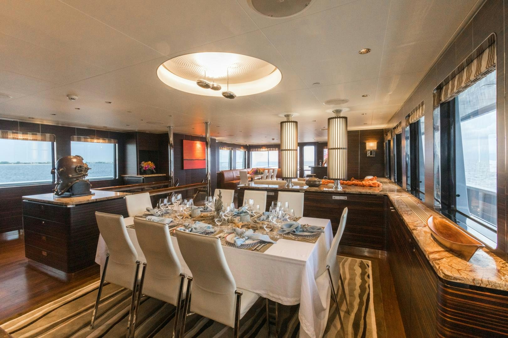 a large kitchen with a dining table aboard QING Yacht for Sale