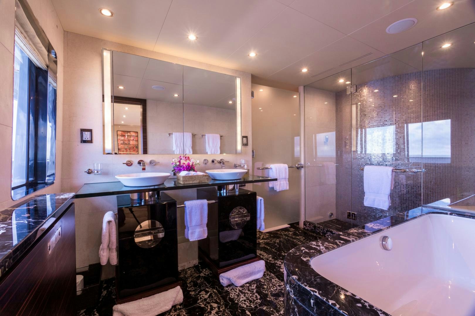 a bathroom with a large mirror aboard QING Yacht for Sale