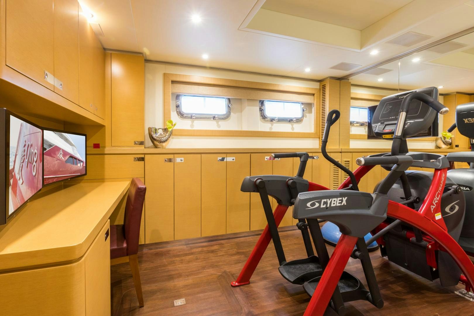a room with a desk and chairs aboard QING Yacht for Sale
