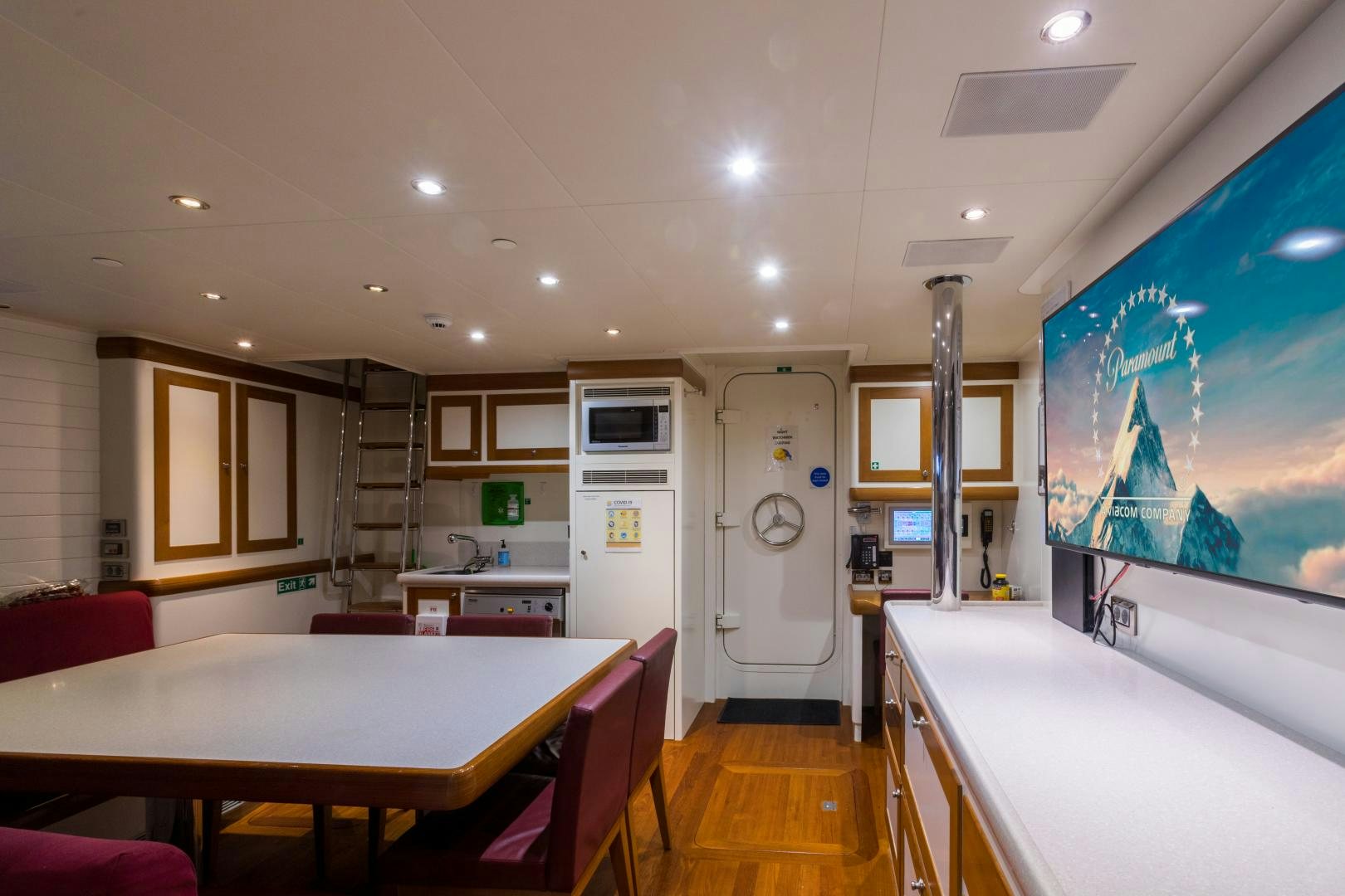 a kitchen with a large screen aboard QING Yacht for Sale