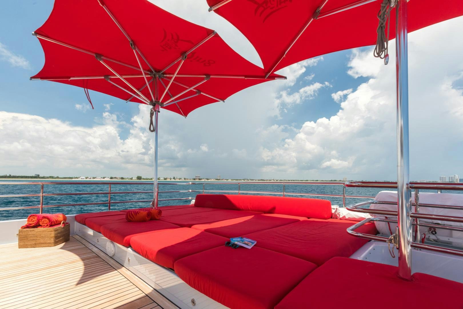 a deck with a large umbrella aboard QING Yacht for Sale