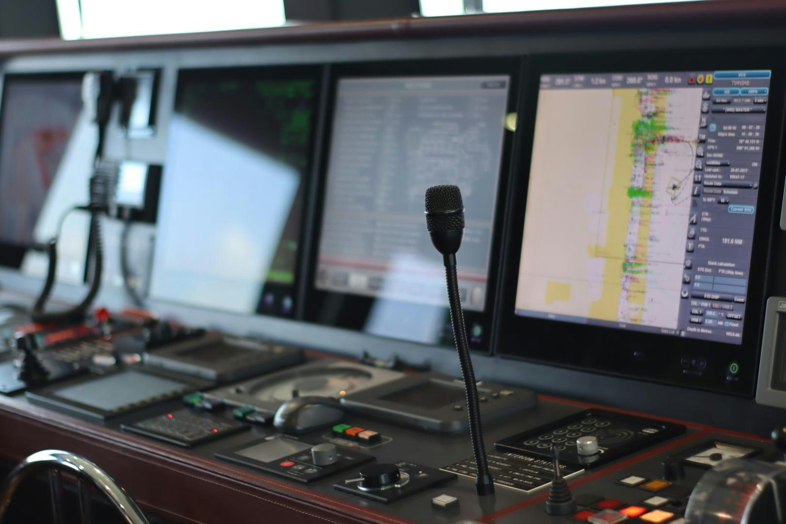 a group of computer screens on a desk aboard QING Yacht for Sale