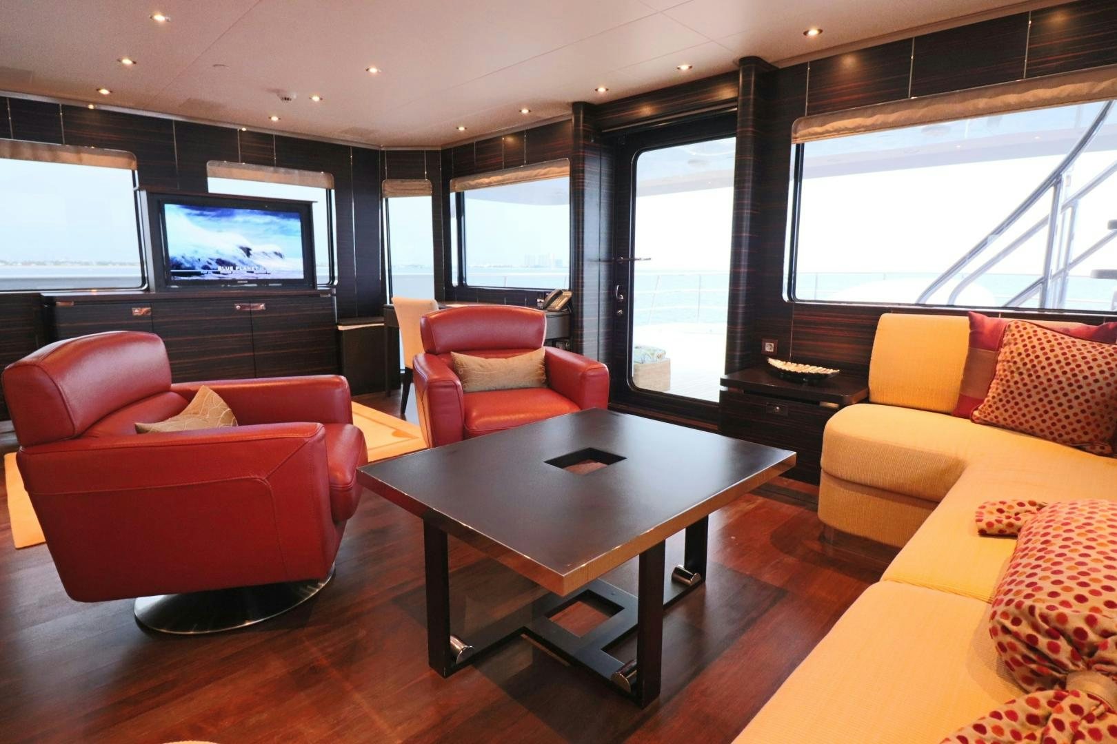 a living room with a table and chairs aboard QING Yacht for Sale