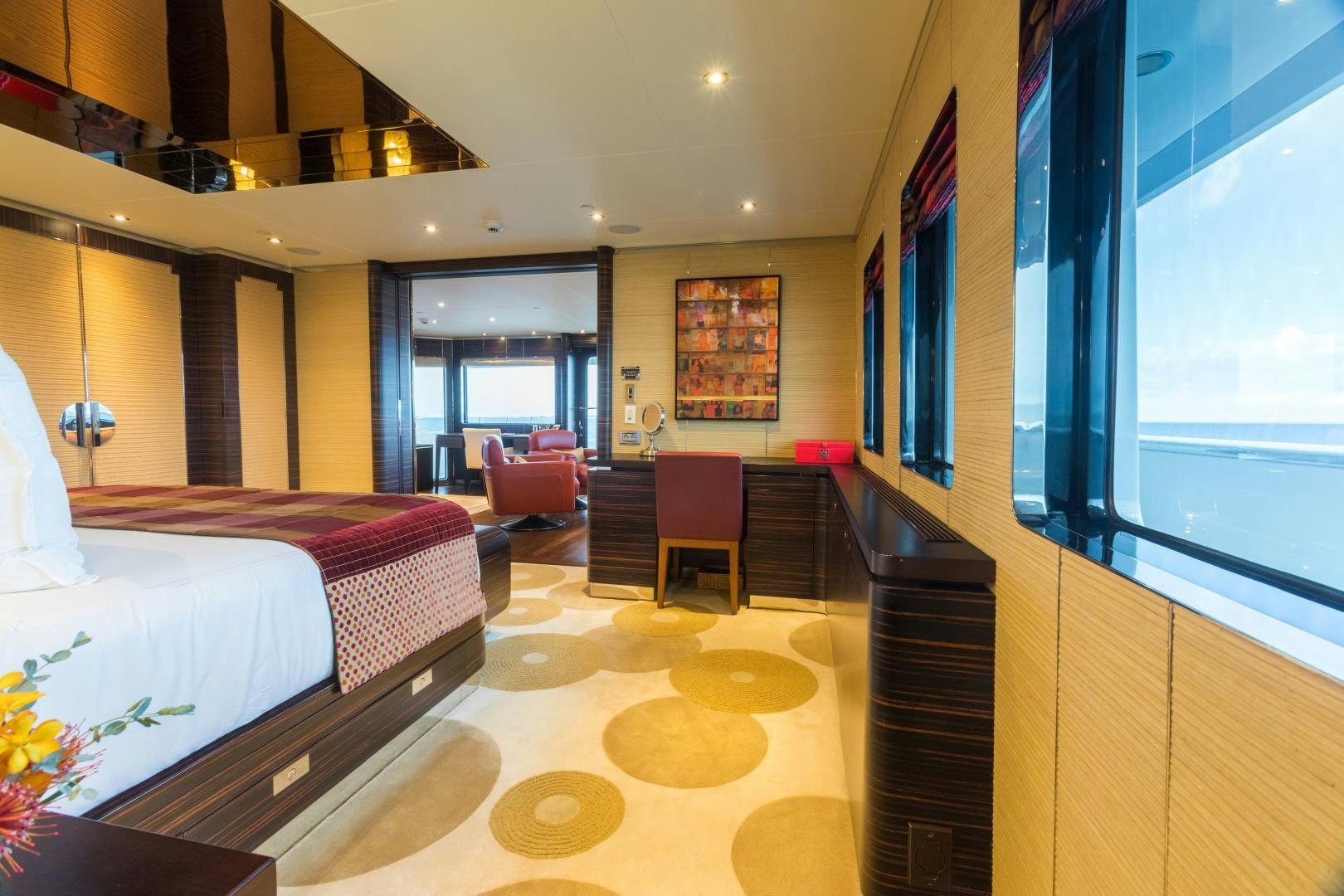 a room with a bed and a chair aboard QING Yacht for Sale