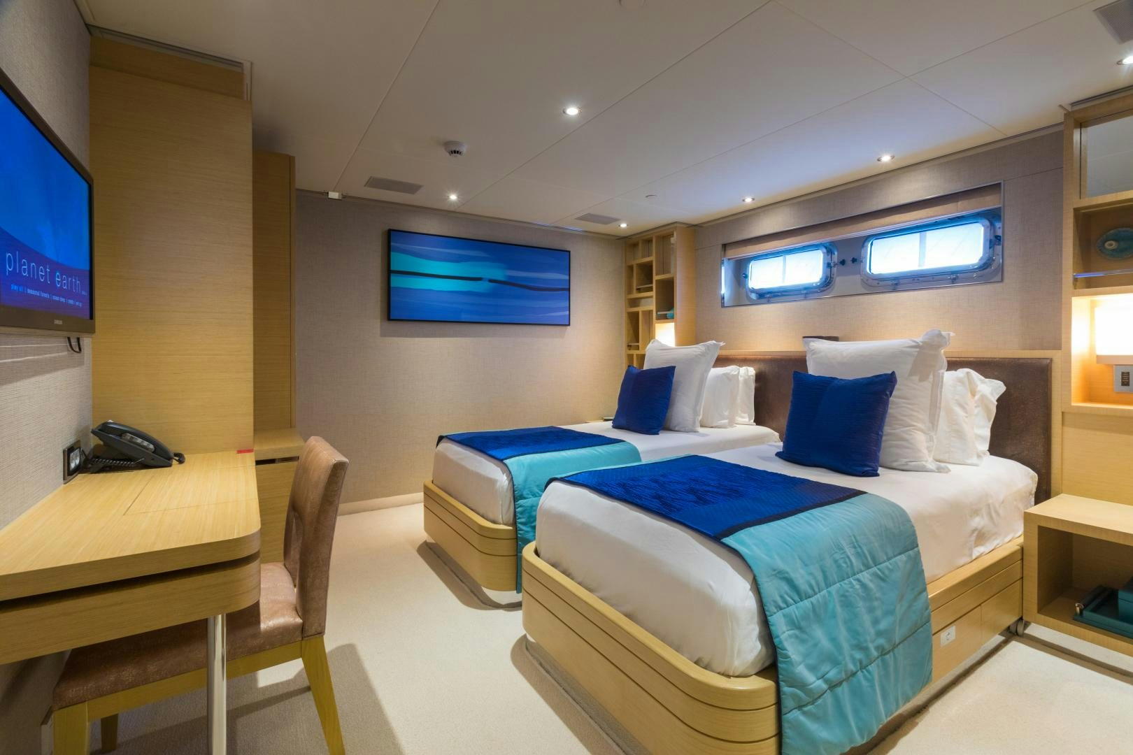 a room with beds and a tv aboard QING Yacht for Sale