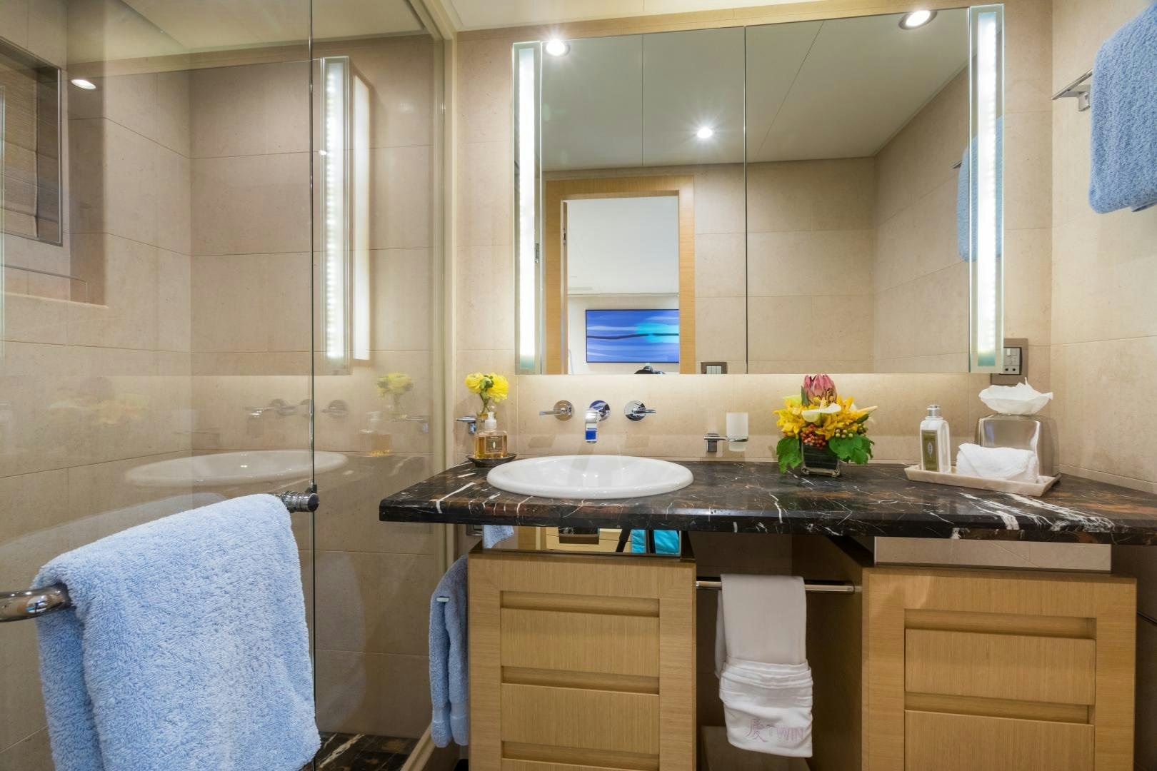 a bathroom with a sink and a shower aboard QING Yacht for Sale