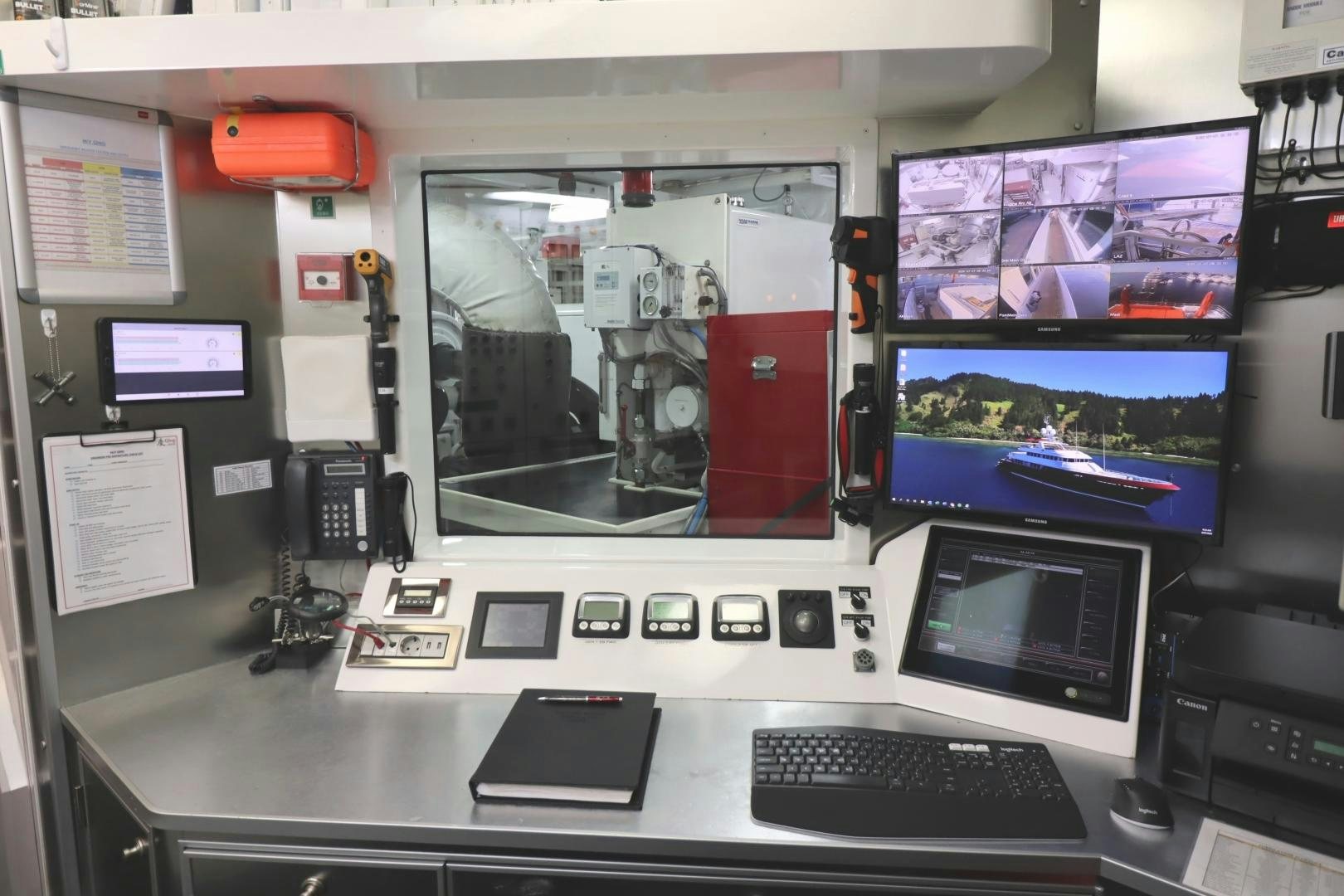 a desk with computers and monitors aboard QING Yacht for Sale