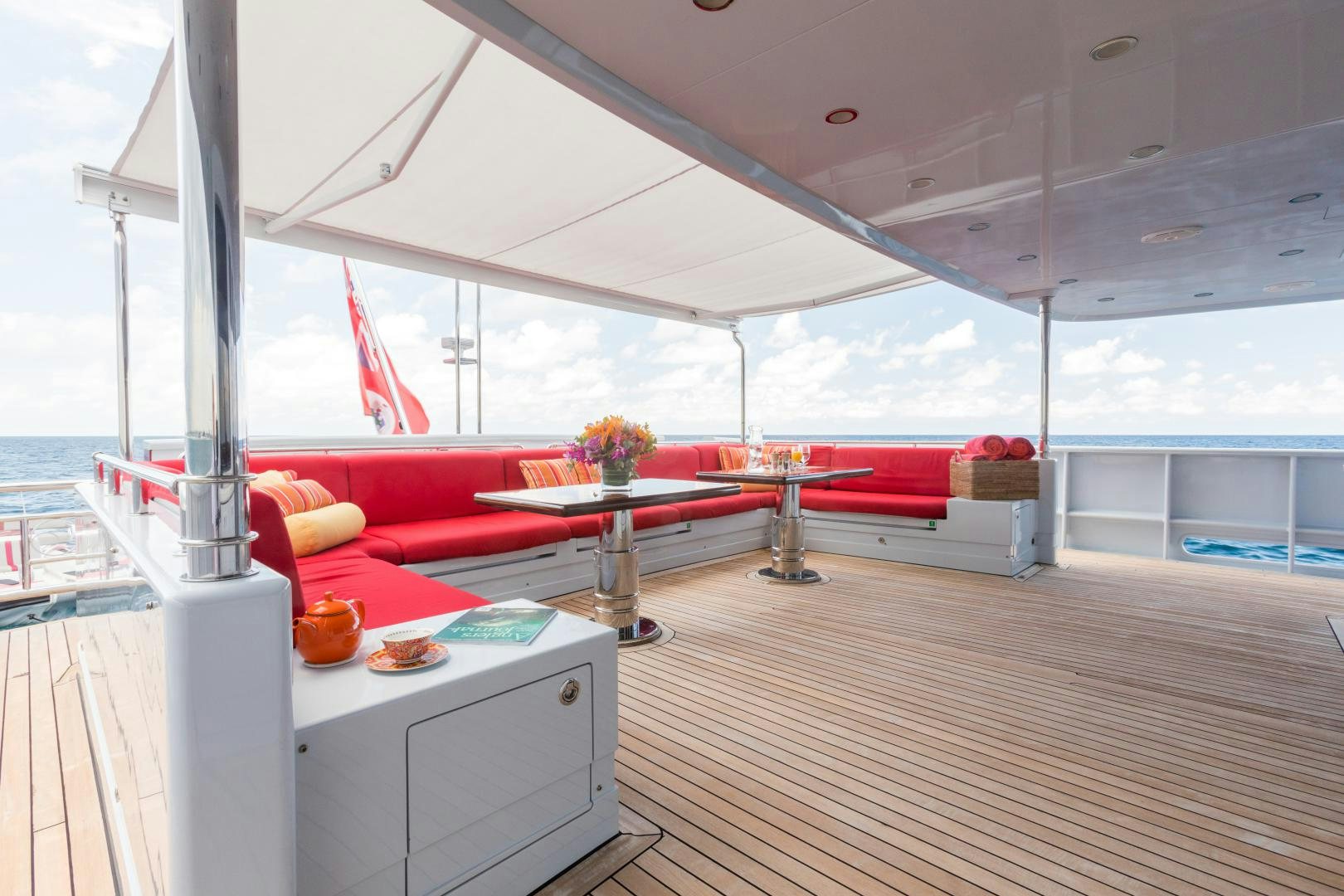 a room with a table and chairs aboard QING Yacht for Sale
