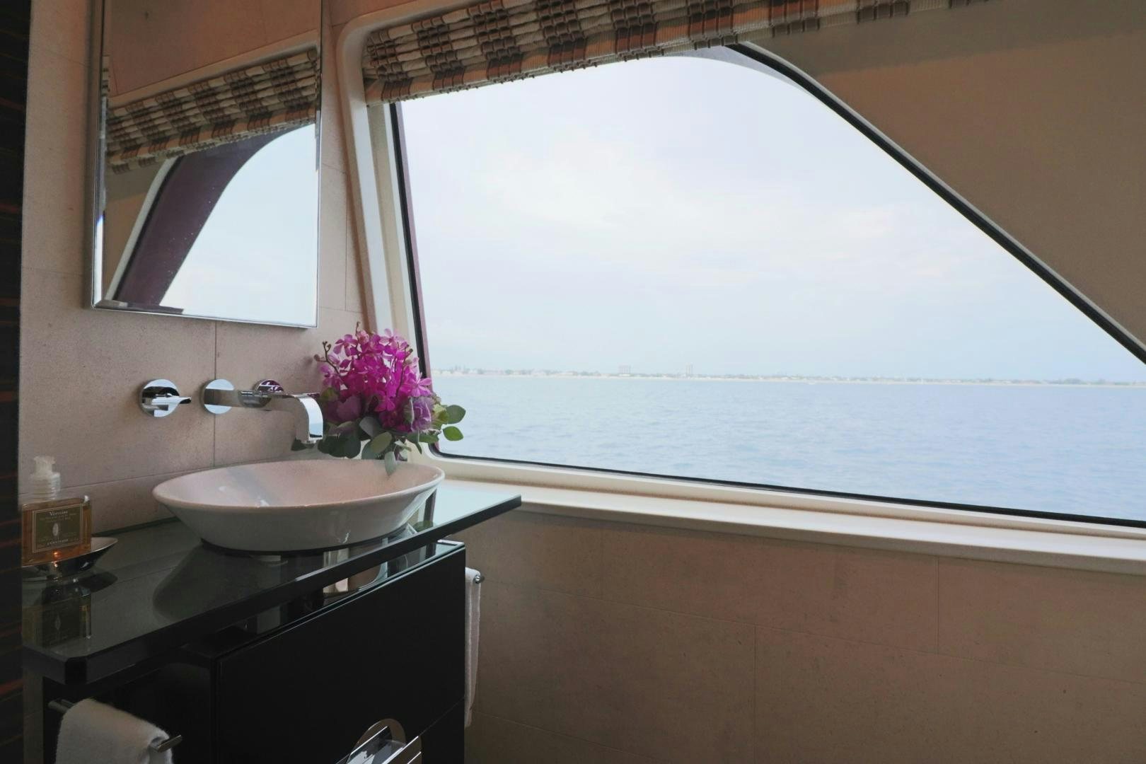 a bathroom with a sink and a large window aboard QING Yacht for Sale