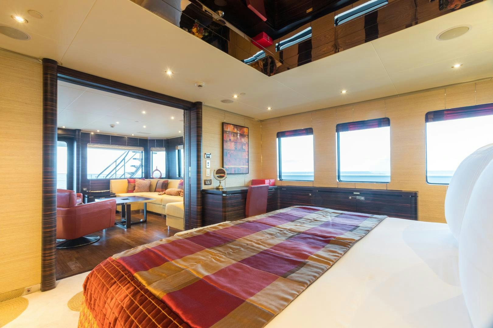 a room with a bed and a couch aboard QING Yacht for Sale