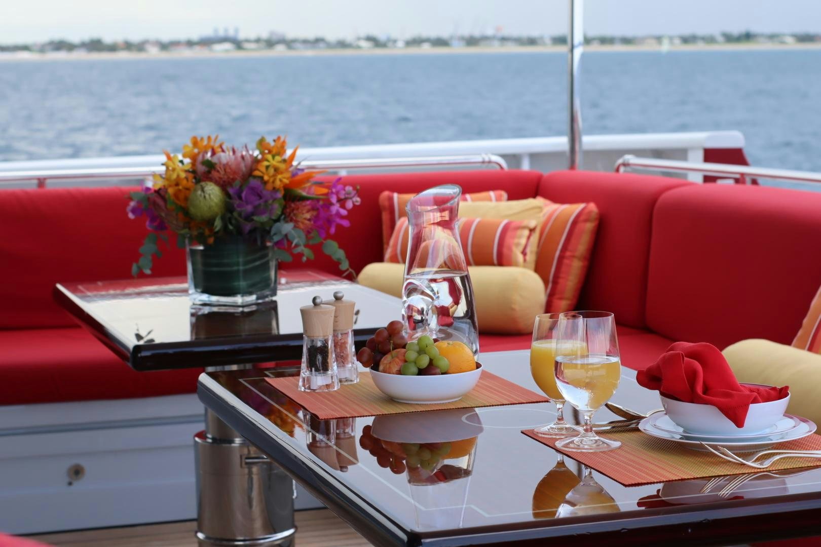 a table with food and drinks on it aboard QING Yacht for Sale