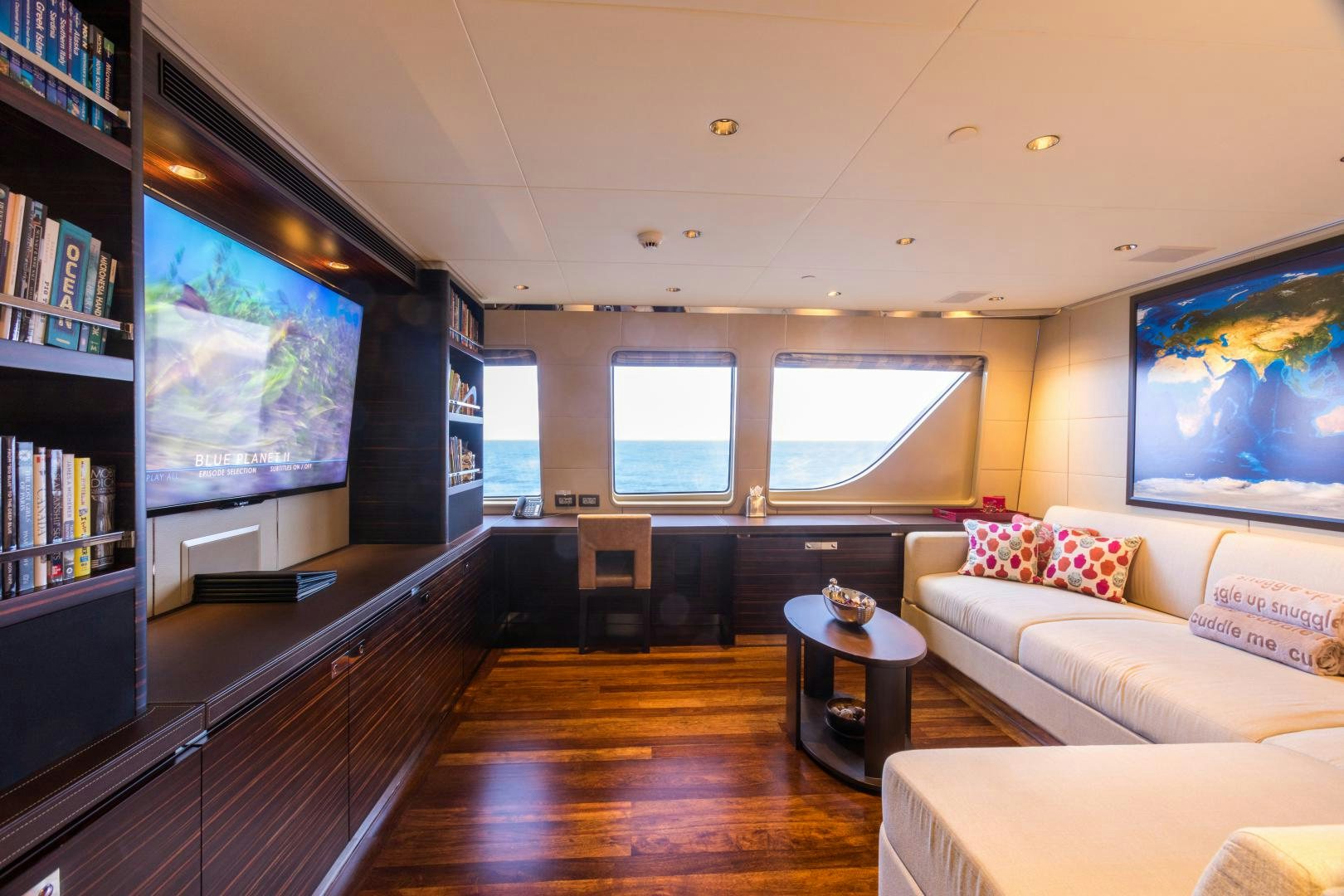 a living room with a large screen aboard QING Yacht for Sale