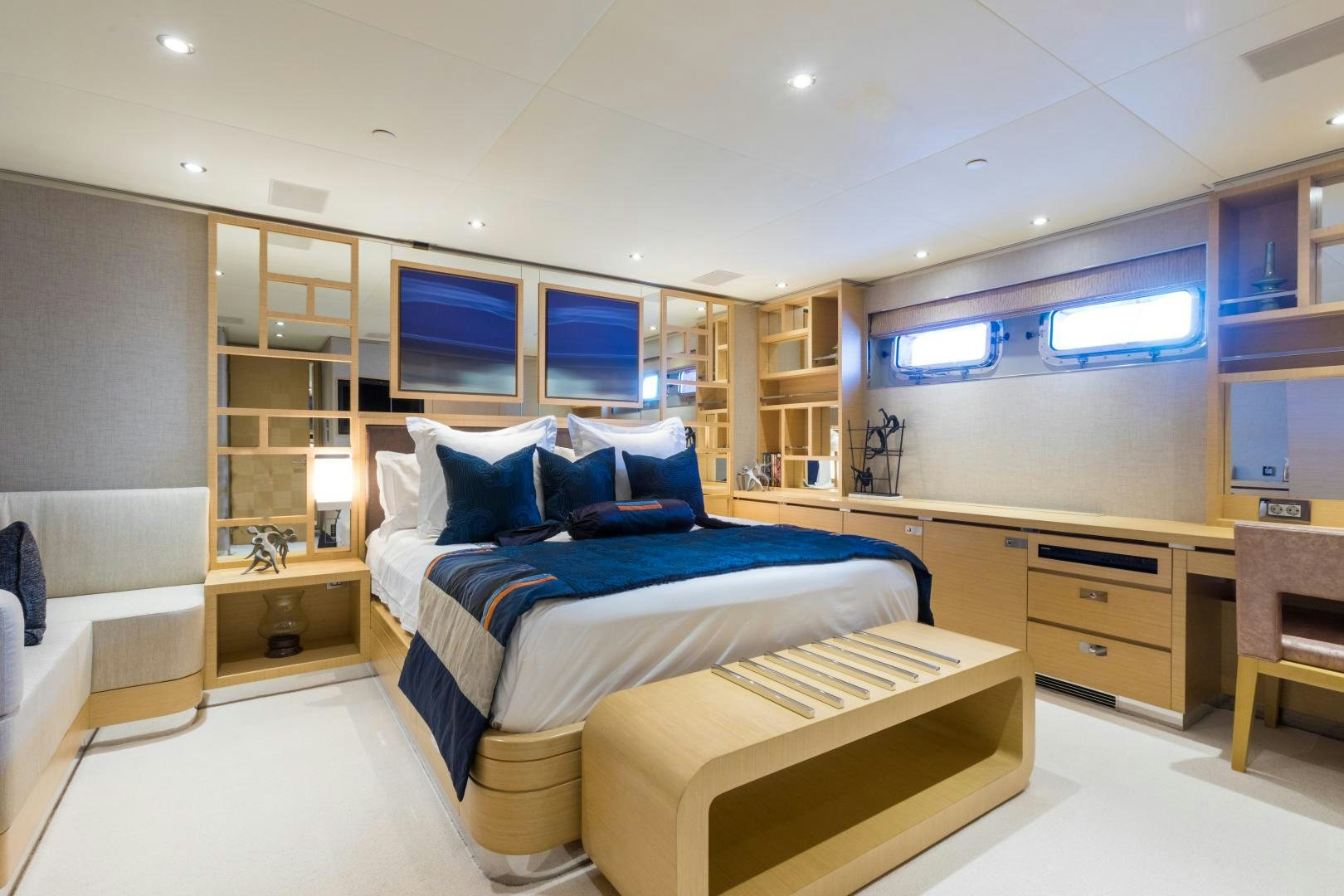 a room with a bed and a desk aboard QING Yacht for Sale