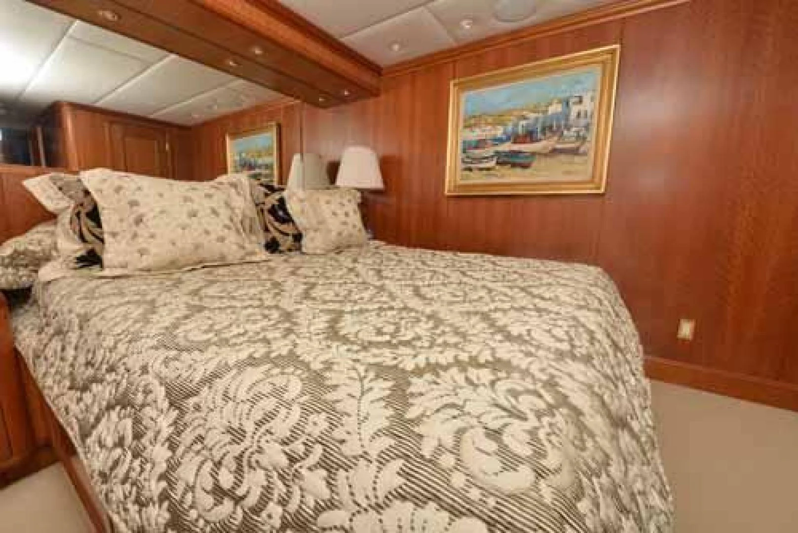 a bed with a white comforter aboard UTOPIA III Yacht for Sale