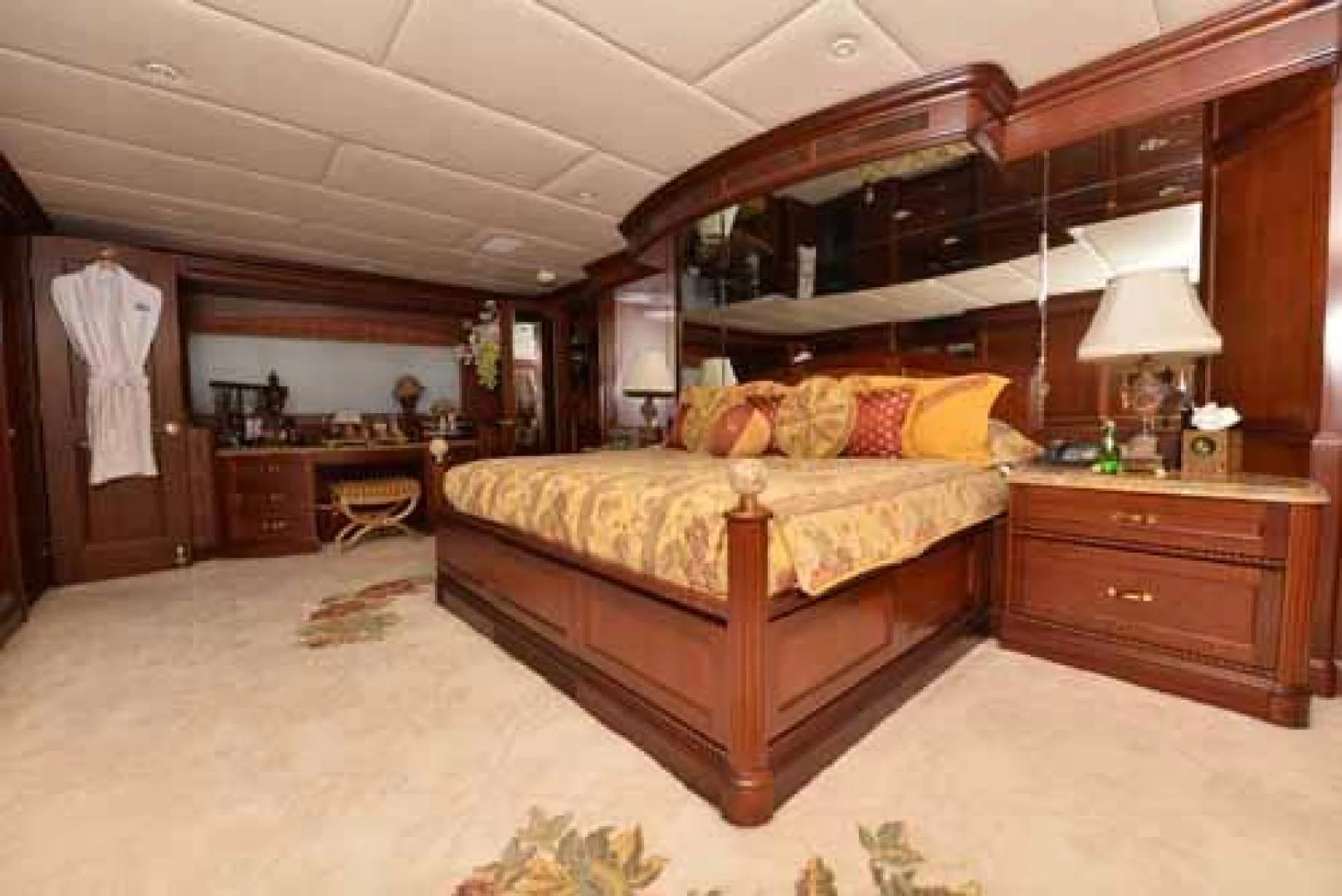 a bedroom with a bed and a desk aboard UTOPIA III Yacht for Sale