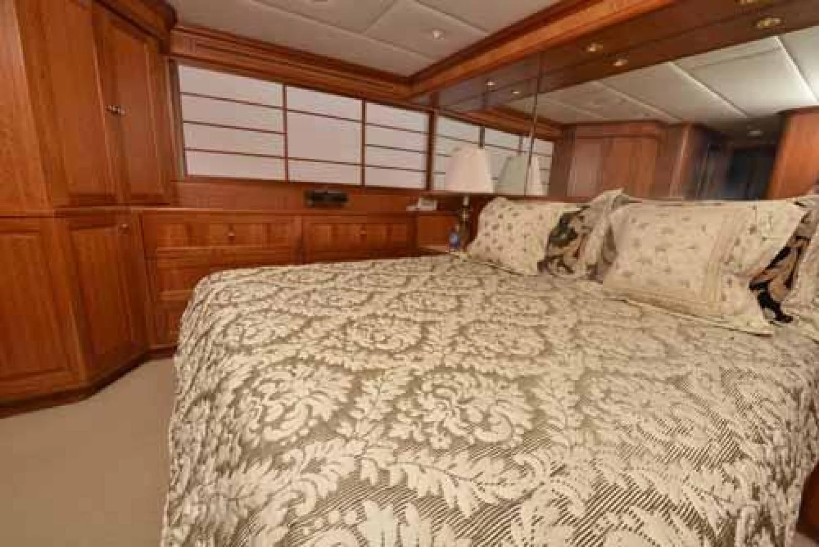 a bed with a white comforter aboard UTOPIA III Yacht for Sale