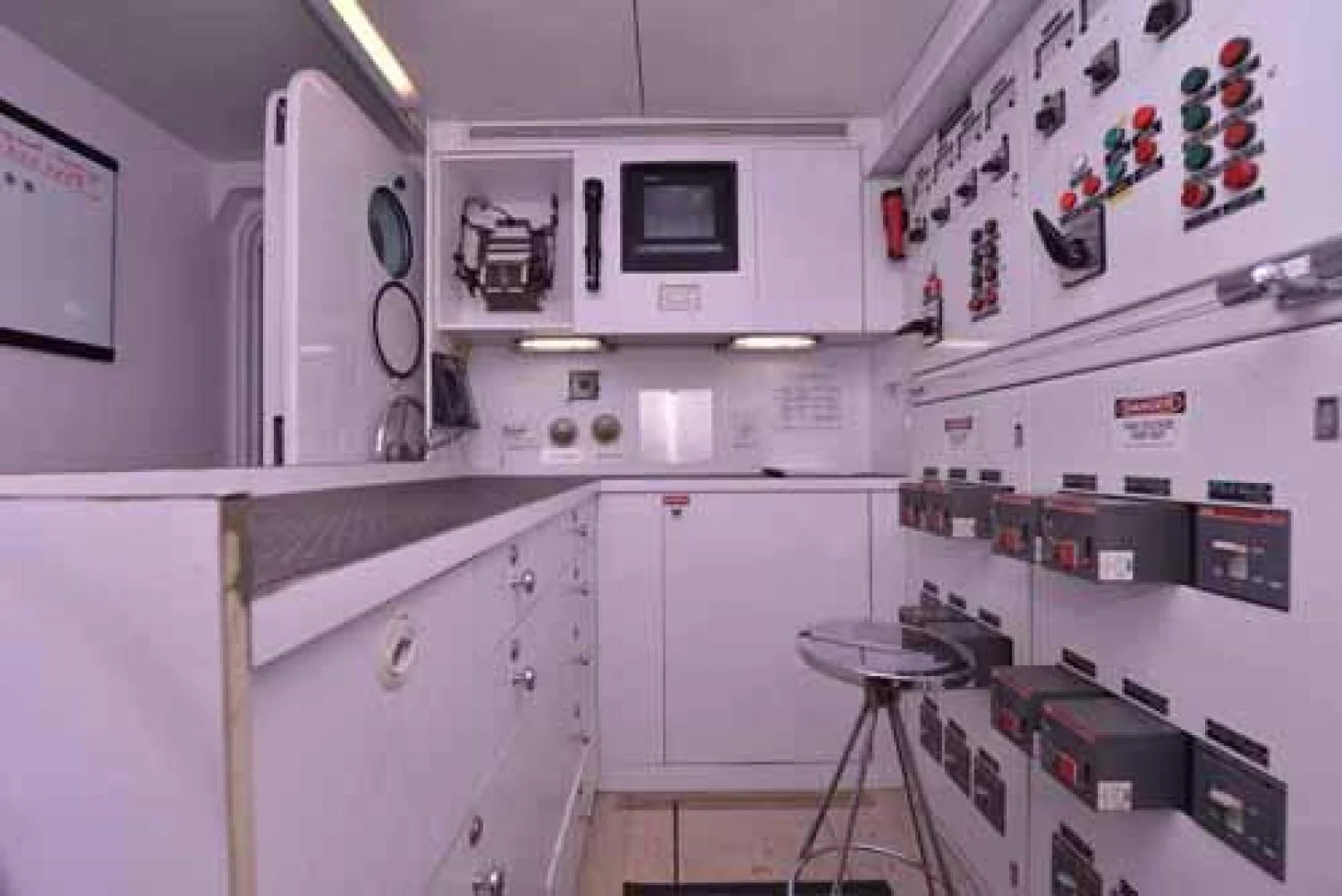 a kitchen with white cabinets aboard UTOPIA III Yacht for Sale