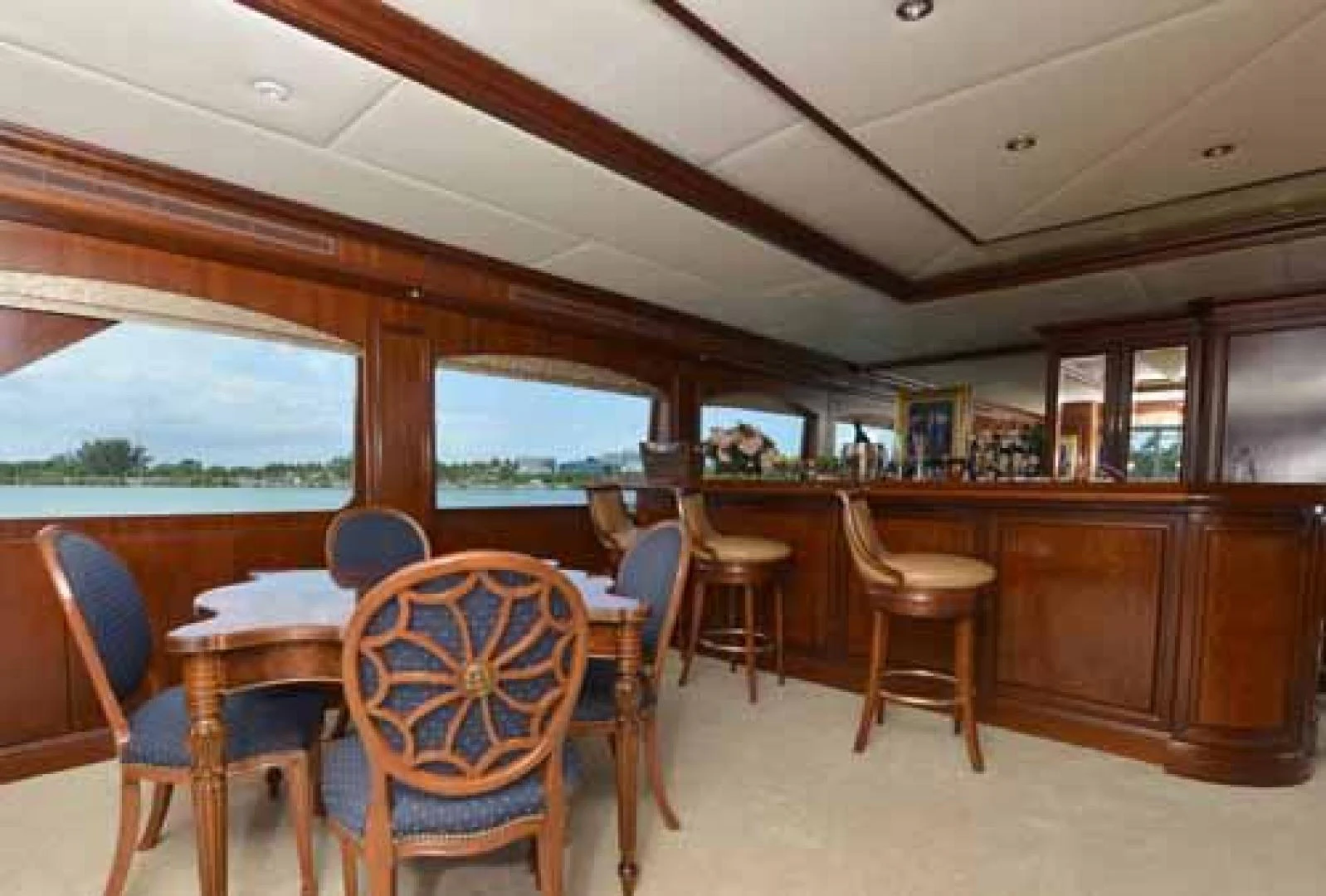 a restaurant with tables and chairs aboard UTOPIA III Yacht for Sale
