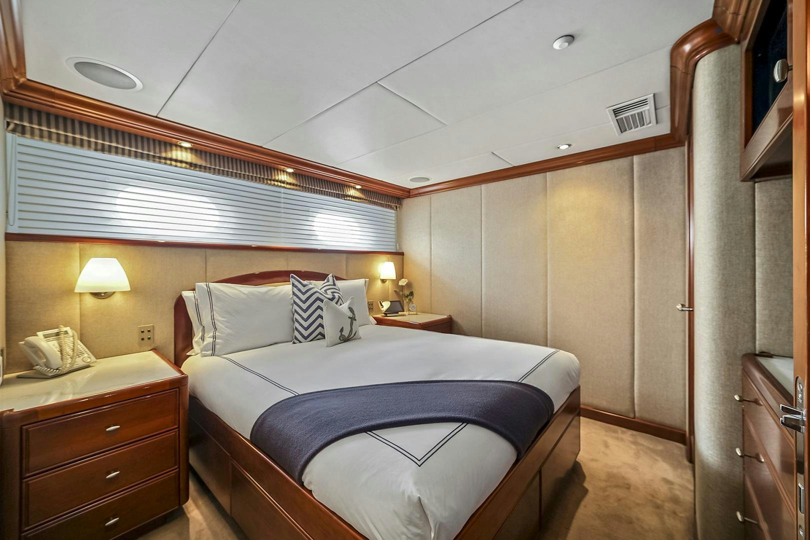 a bedroom with a bed and a desk aboard ARTEMIS Yacht for Sale