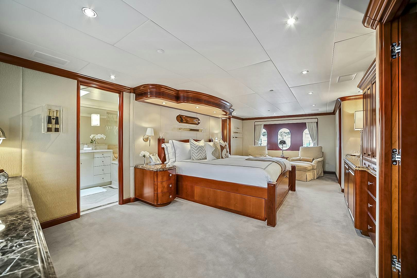 a bedroom with a bed and a desk aboard ARTEMIS Yacht for Sale
