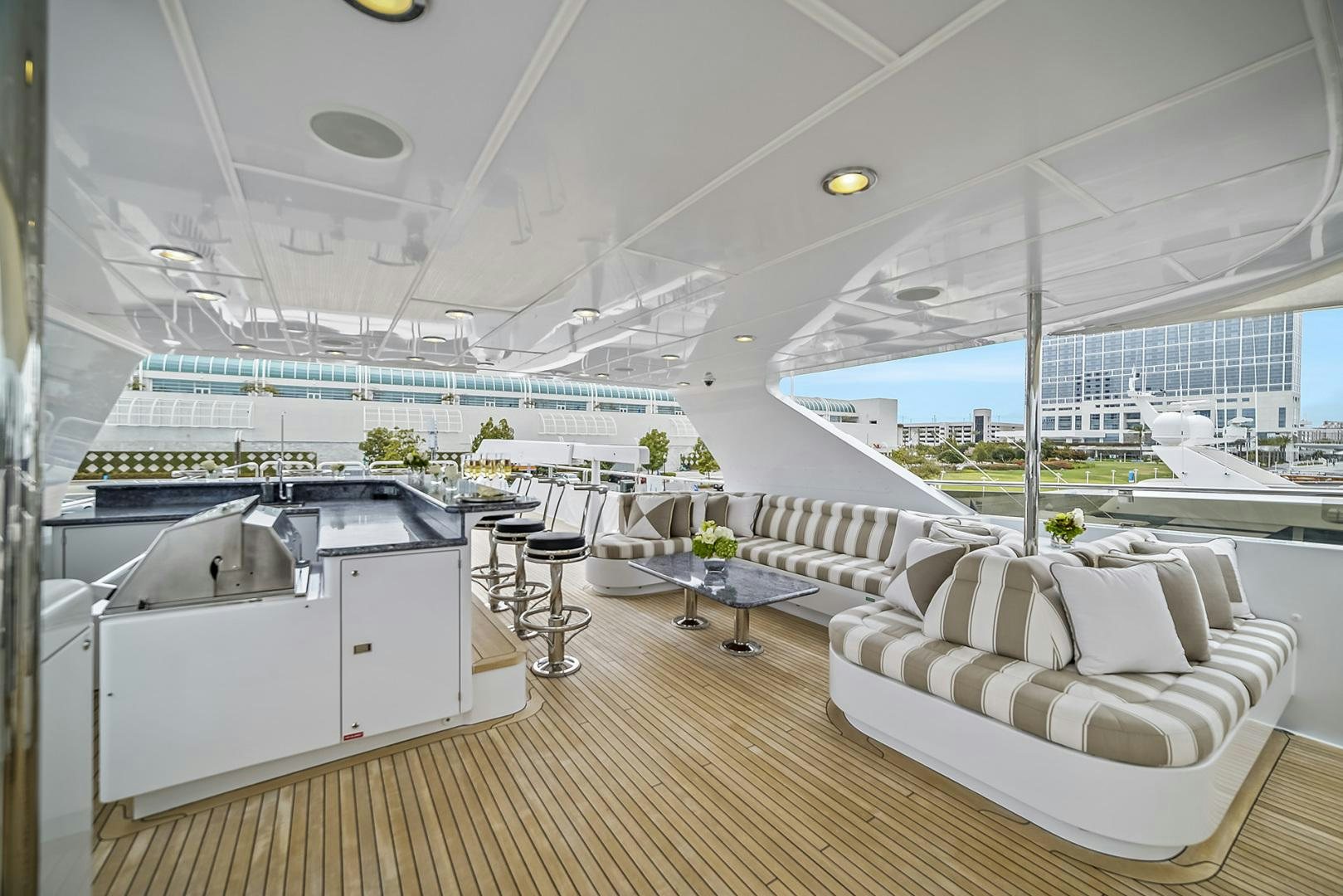 a large room with a couch and a table and chairs aboard ARTEMIS Yacht for Sale