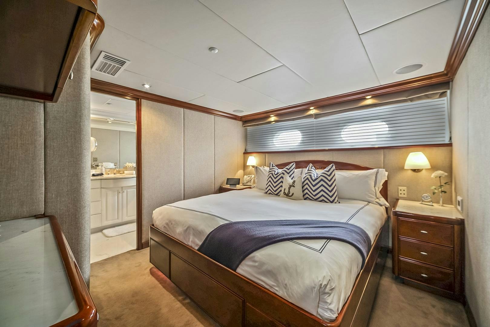 a bedroom with a bed and a desk aboard ARTEMIS Yacht for Sale