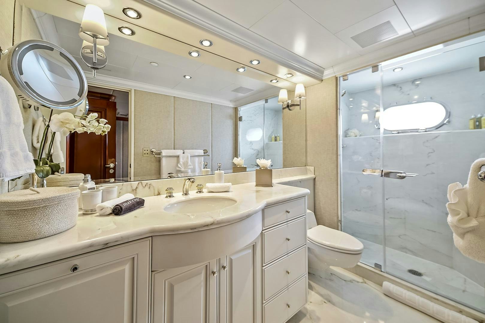 a bathroom with a glass shower aboard ARTEMIS Yacht for Sale