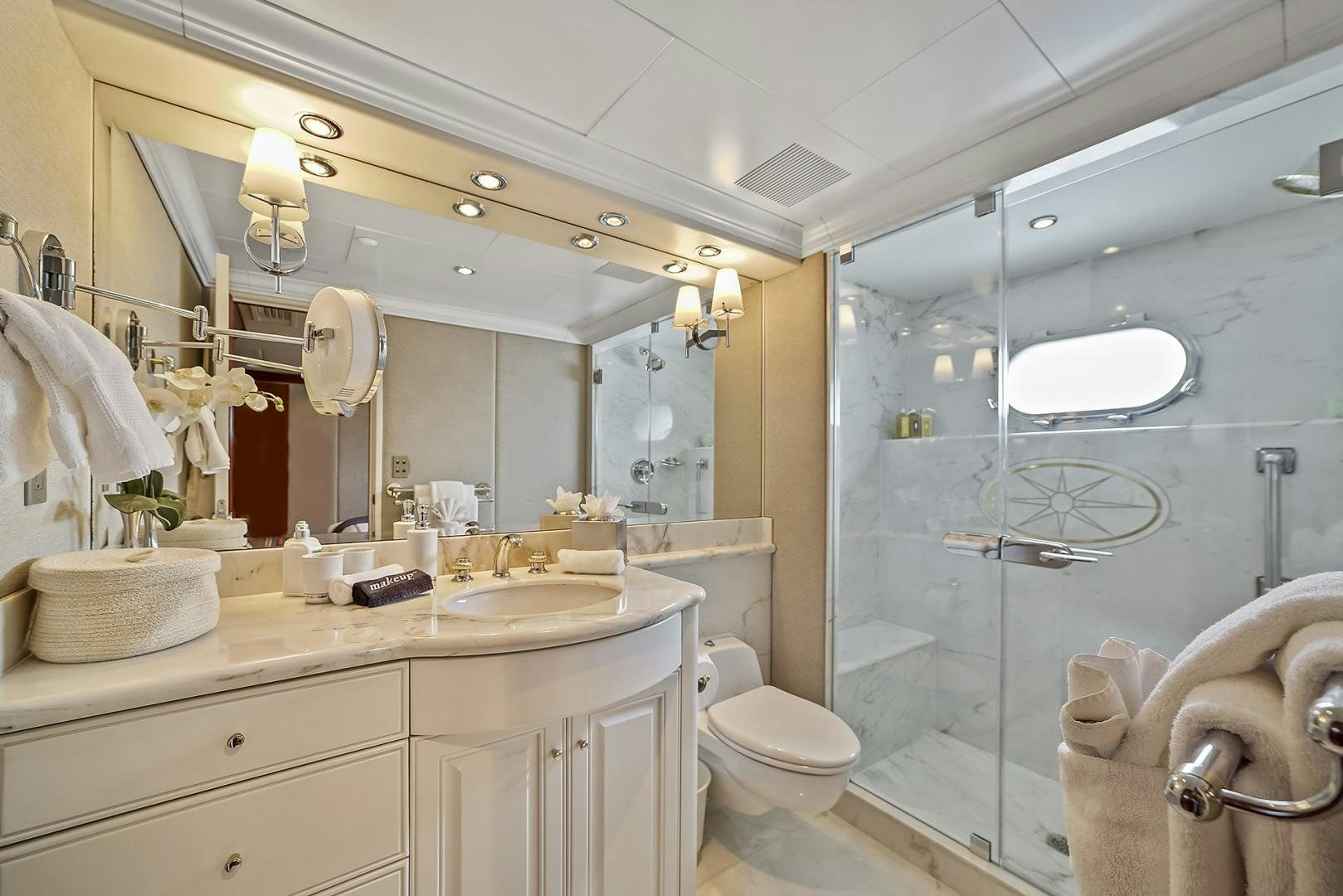 a bathroom with a glass shower aboard ARTEMIS Yacht for Sale